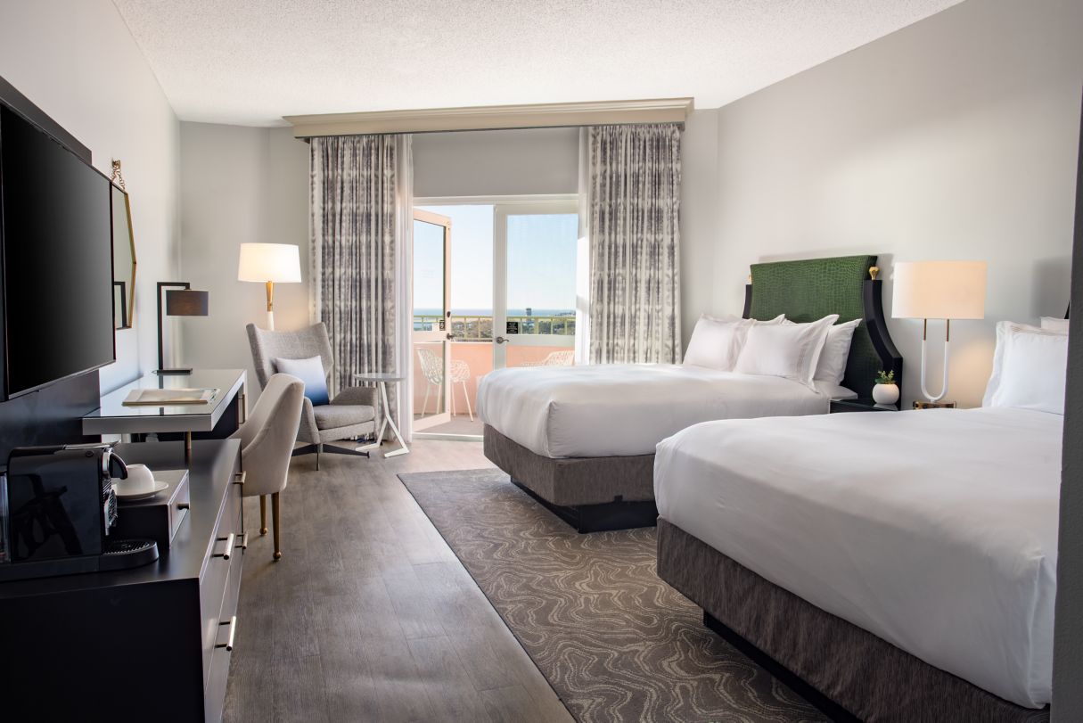 a room with two beds and a desk