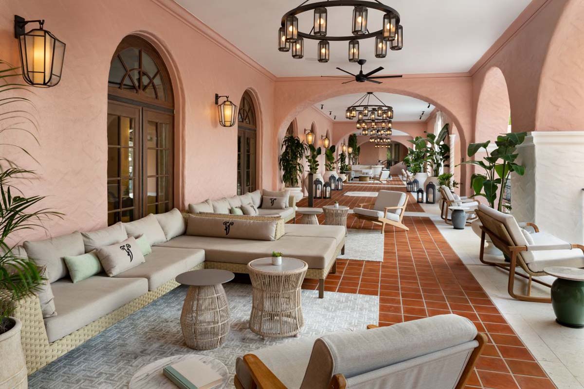 a room with a large couch and chairs