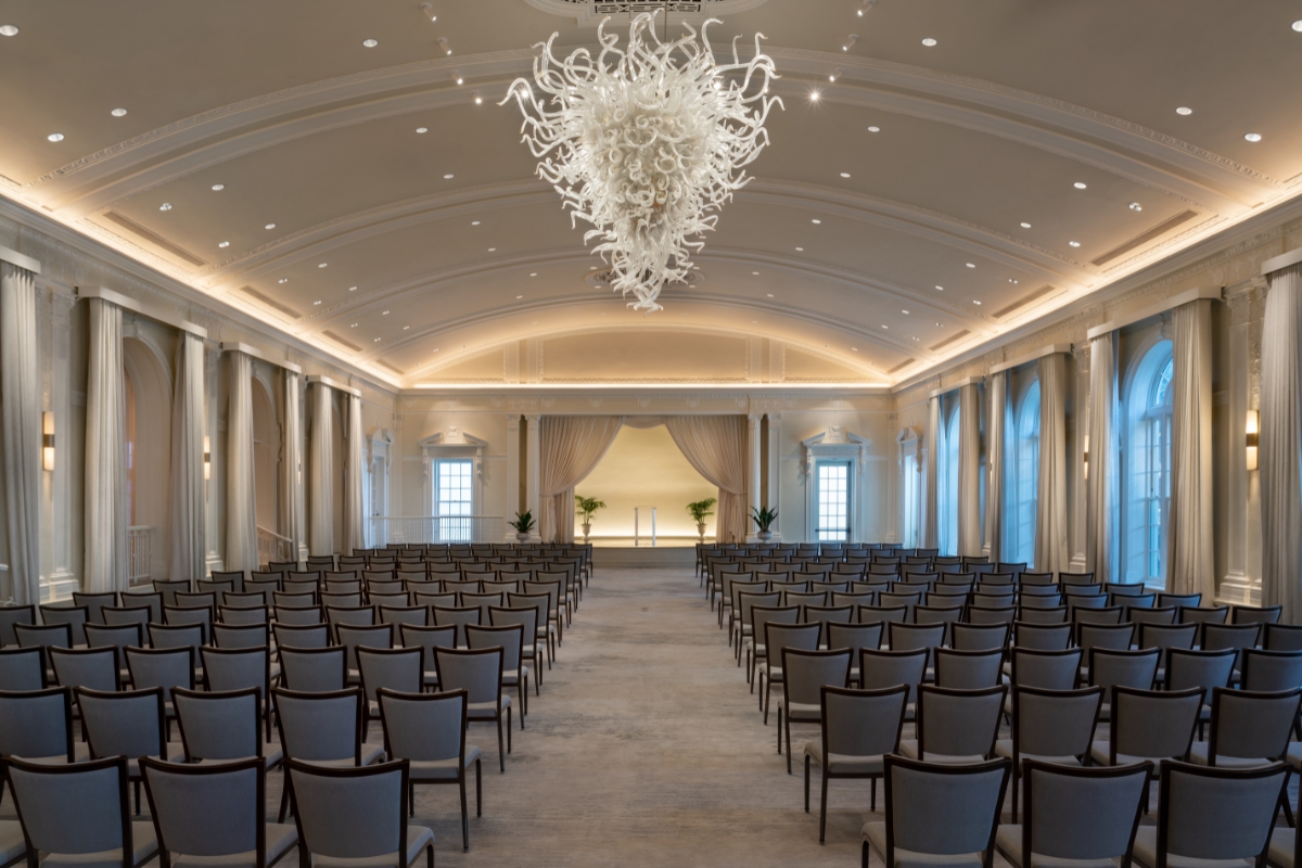 a room with chairs and a chandelier