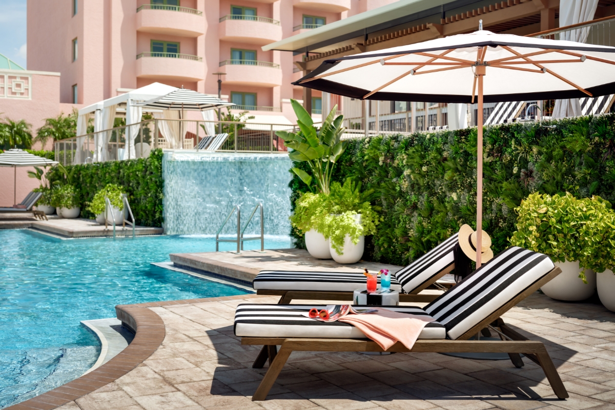a pool with chairs and umbrellas