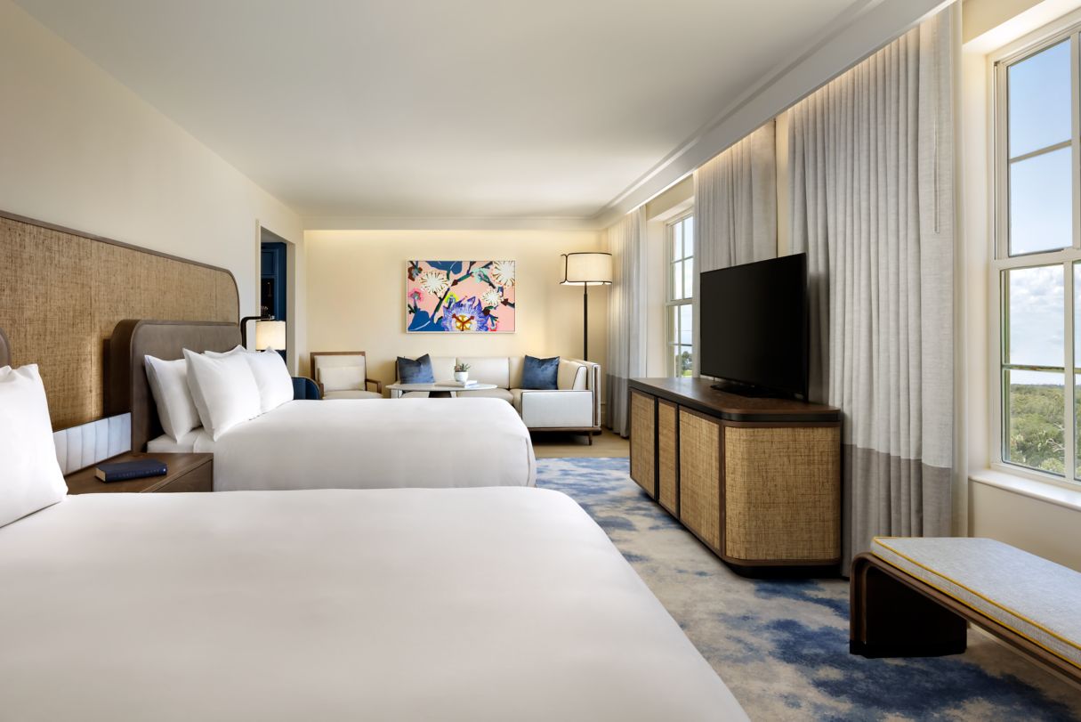 a room with two beds and a tv
