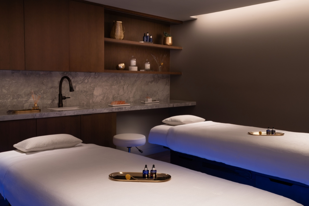 a massage room with two beds