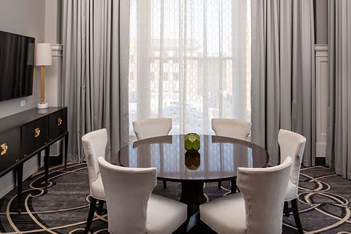 a room with a round table and chairs