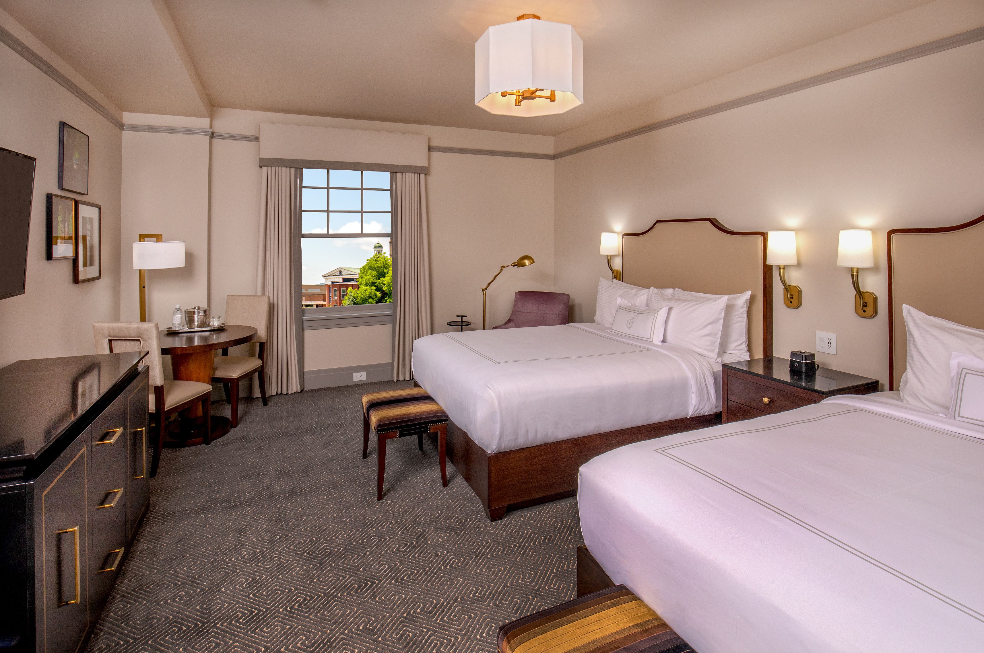 a room with two beds and a table