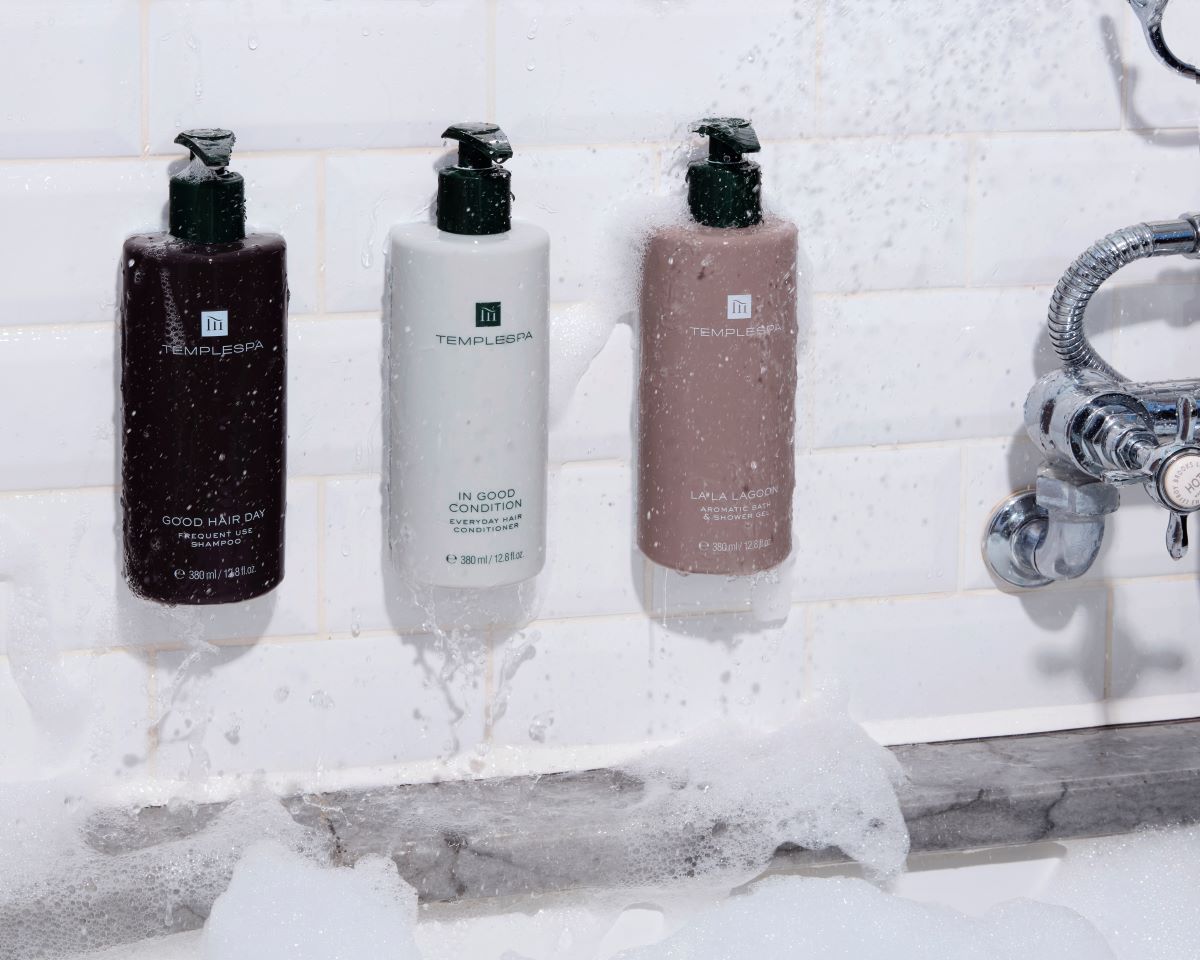 a group of bottles of liquid in a bathtub