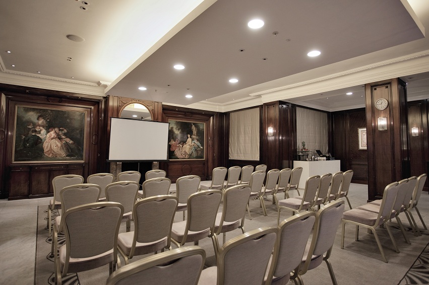 a room with chairs and a projector screen