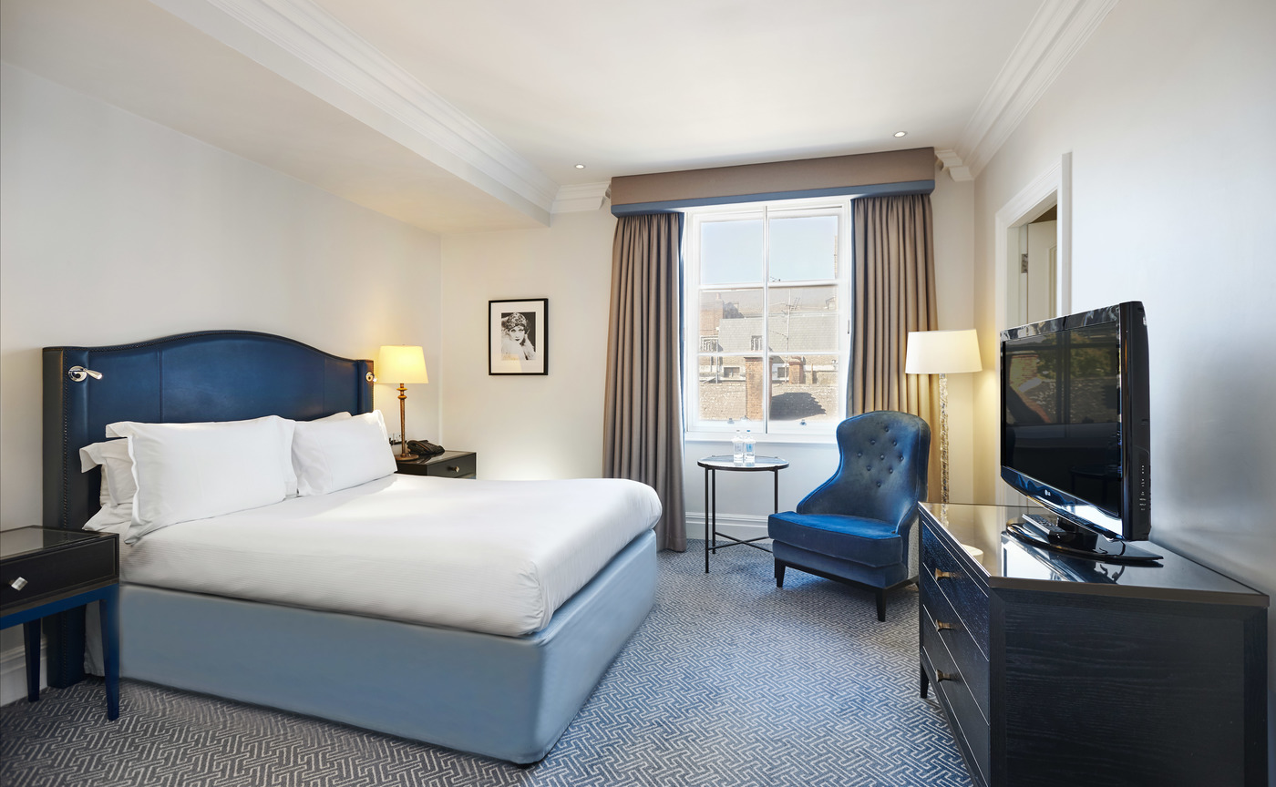a room with a bed and a television