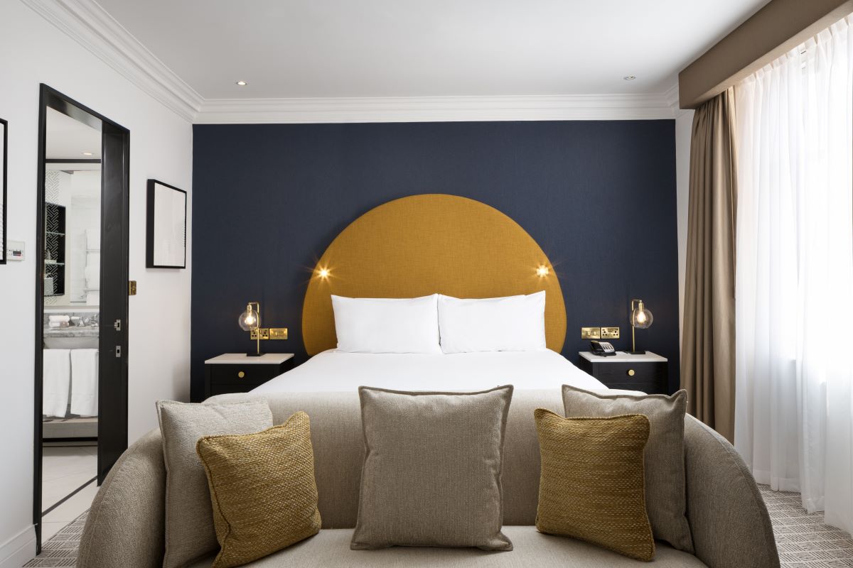 a bed with pillows and a couch in a room
