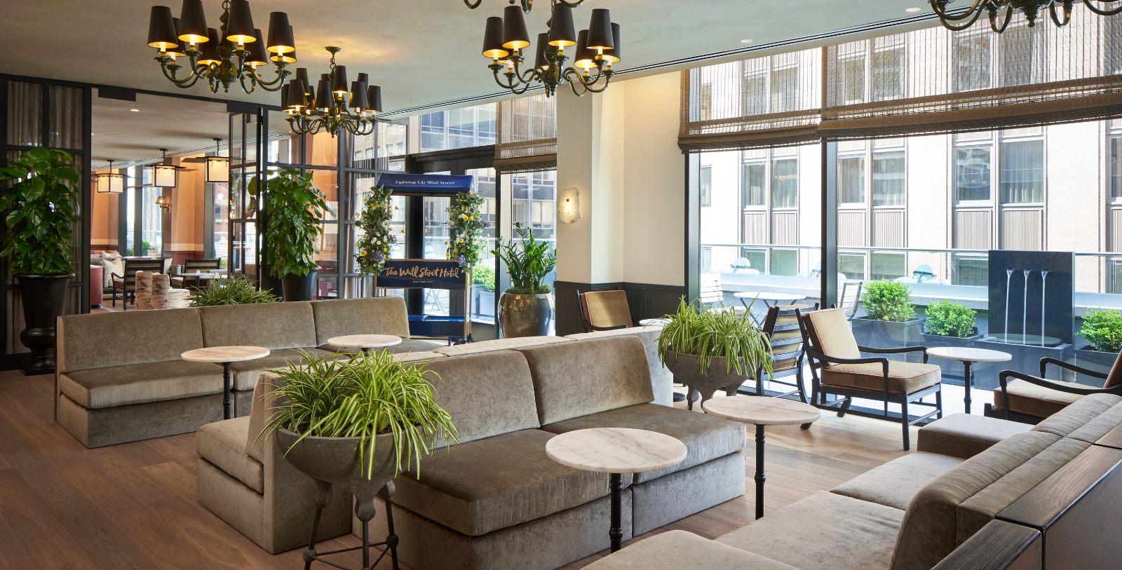a room with couches and tables and plants