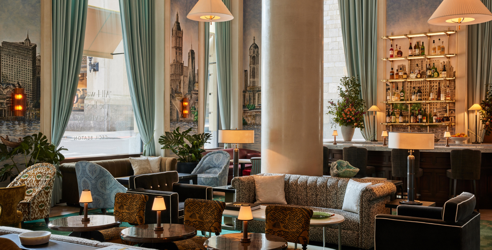 a room with a large column and a couch and chairs