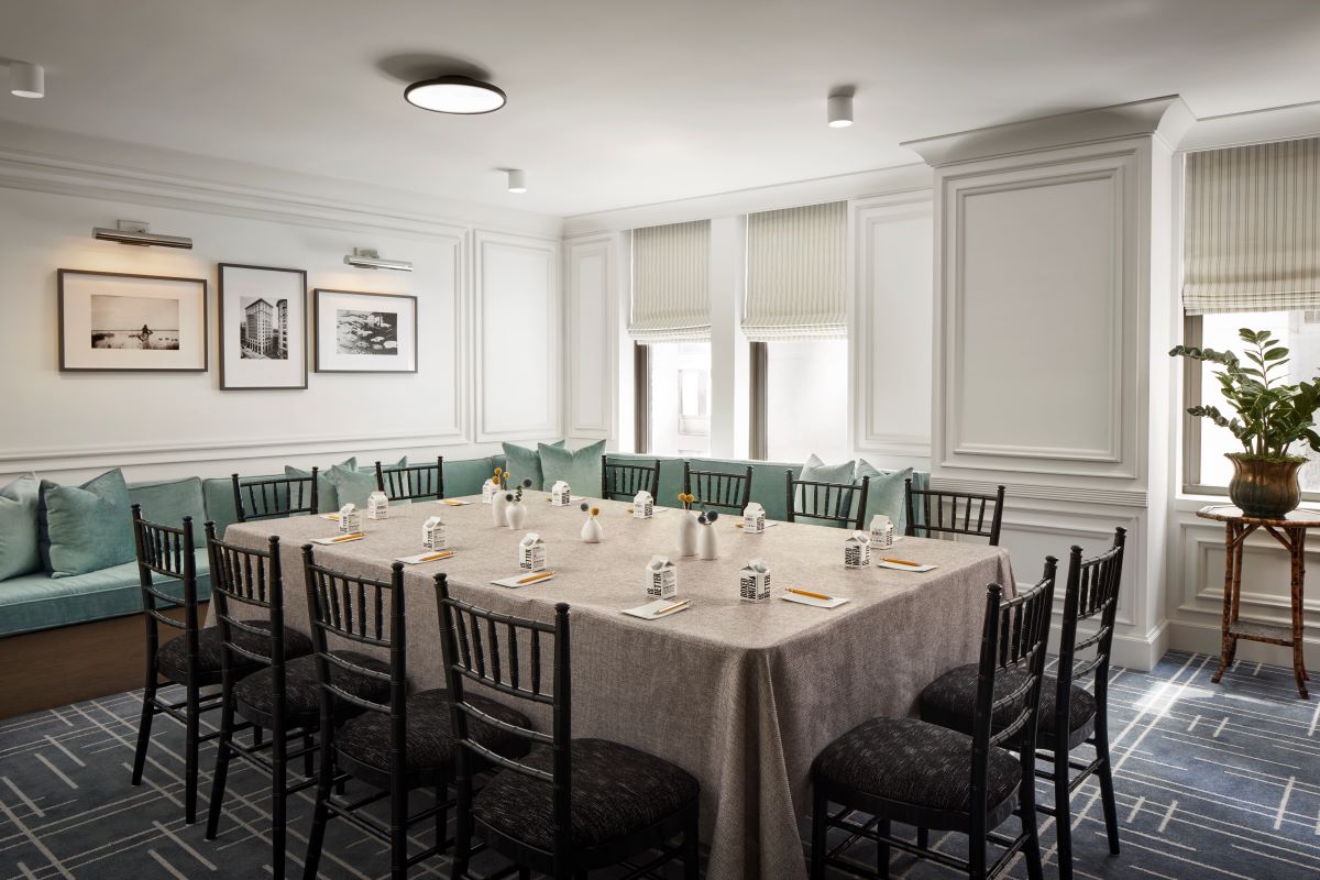 a table with a tablecloth and chairs in a room