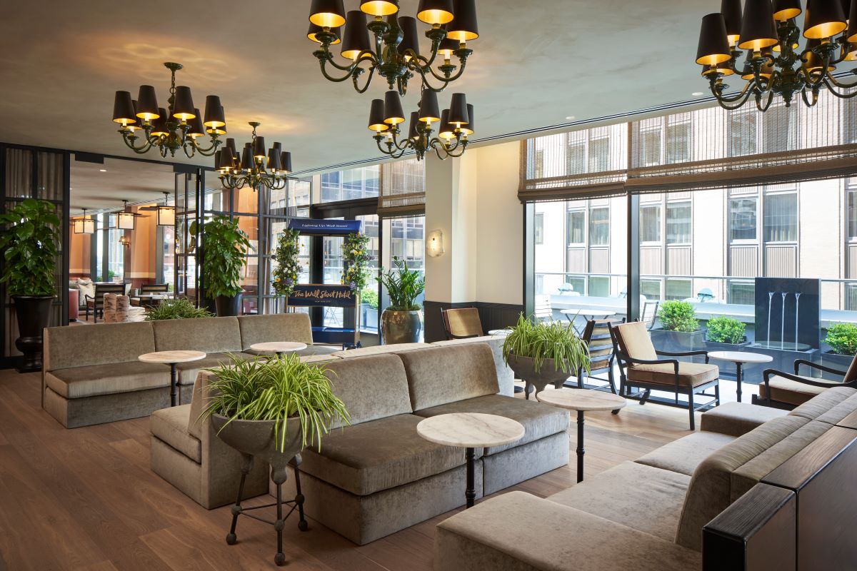 a room with couches and tables and plants