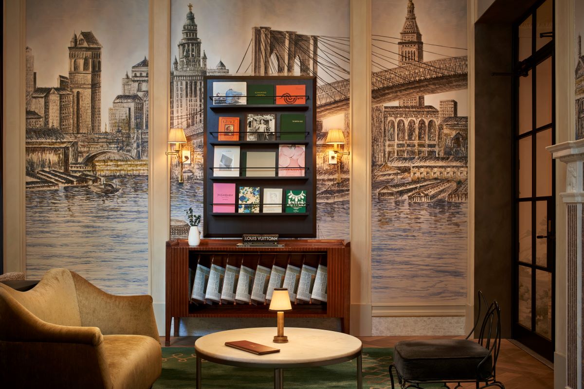 a room with a table and chairs and a table with a picture of a bridge and a river