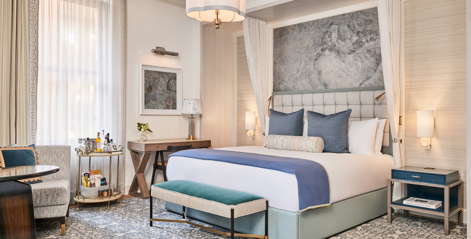 a bed with a lamp and a table