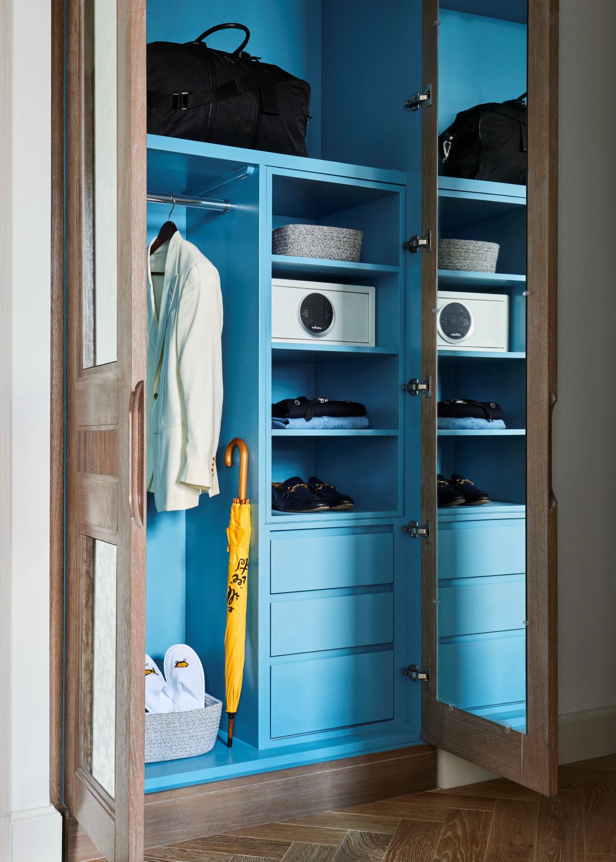a closet with blue shelves and a white object
