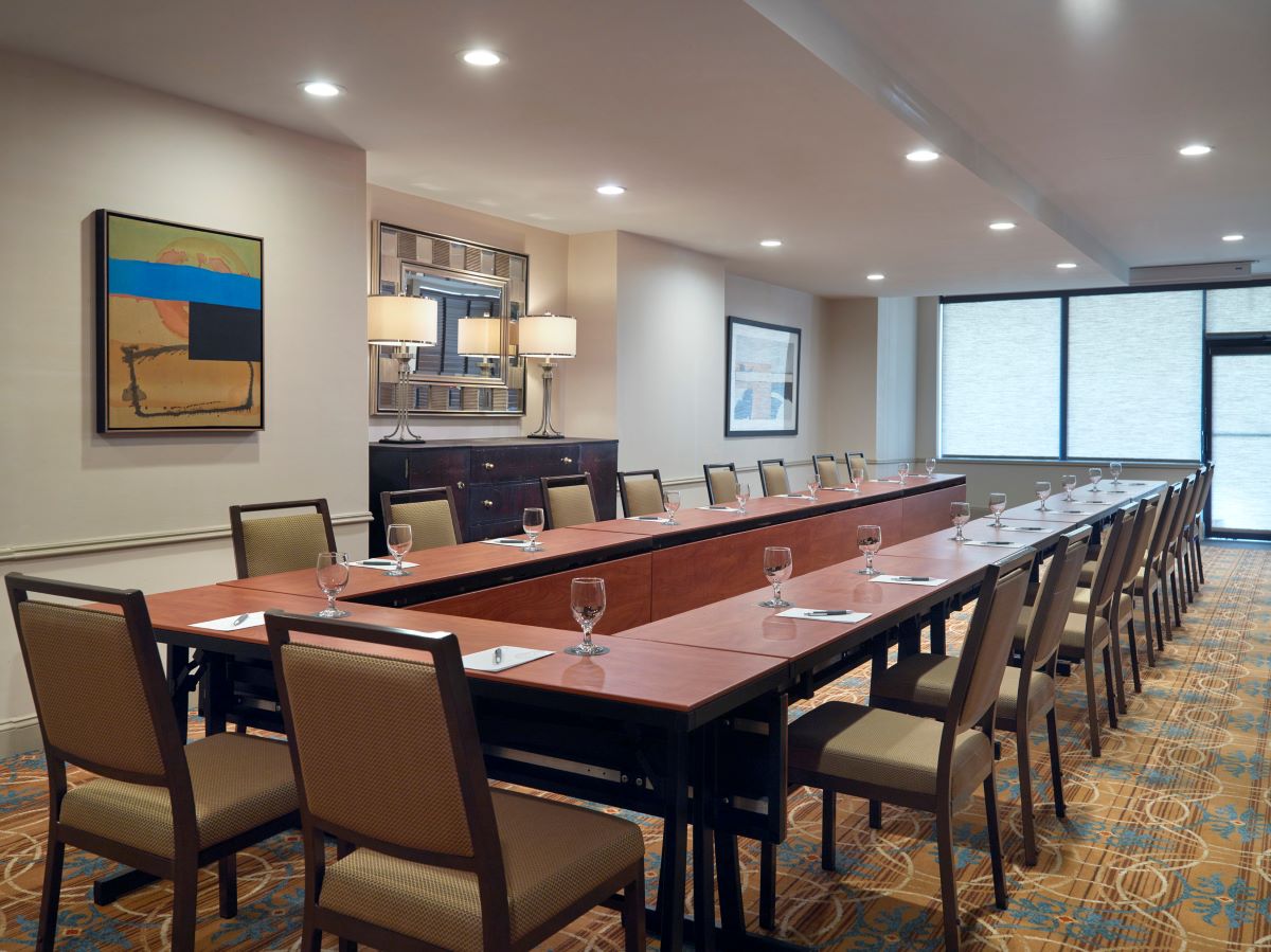 a long conference room with a long table and chairs