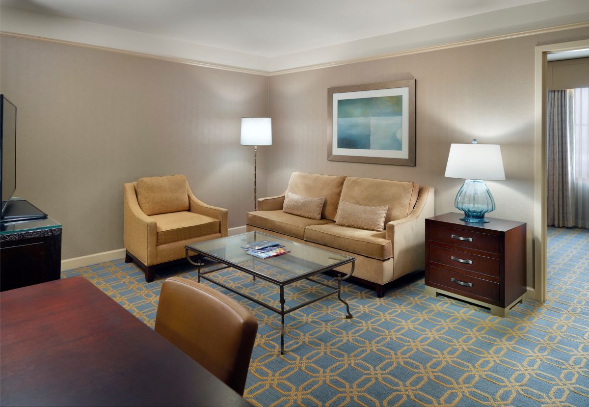 a room with a couch and chairs