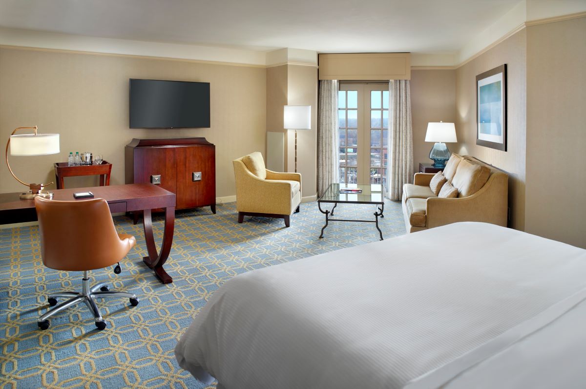a room with a bed and a television