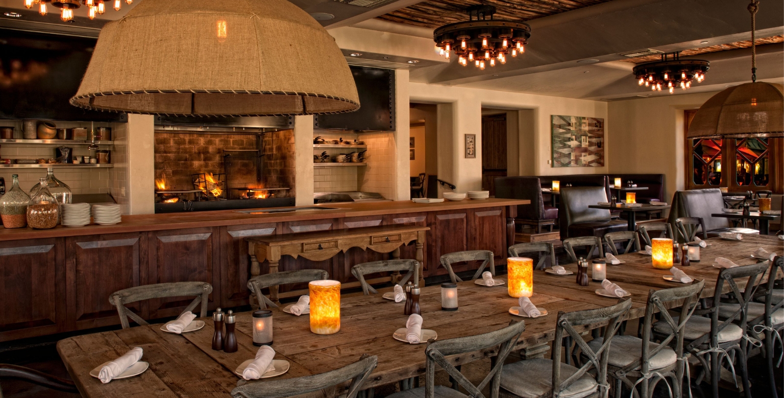 a table with candles and chairs in a restaurant