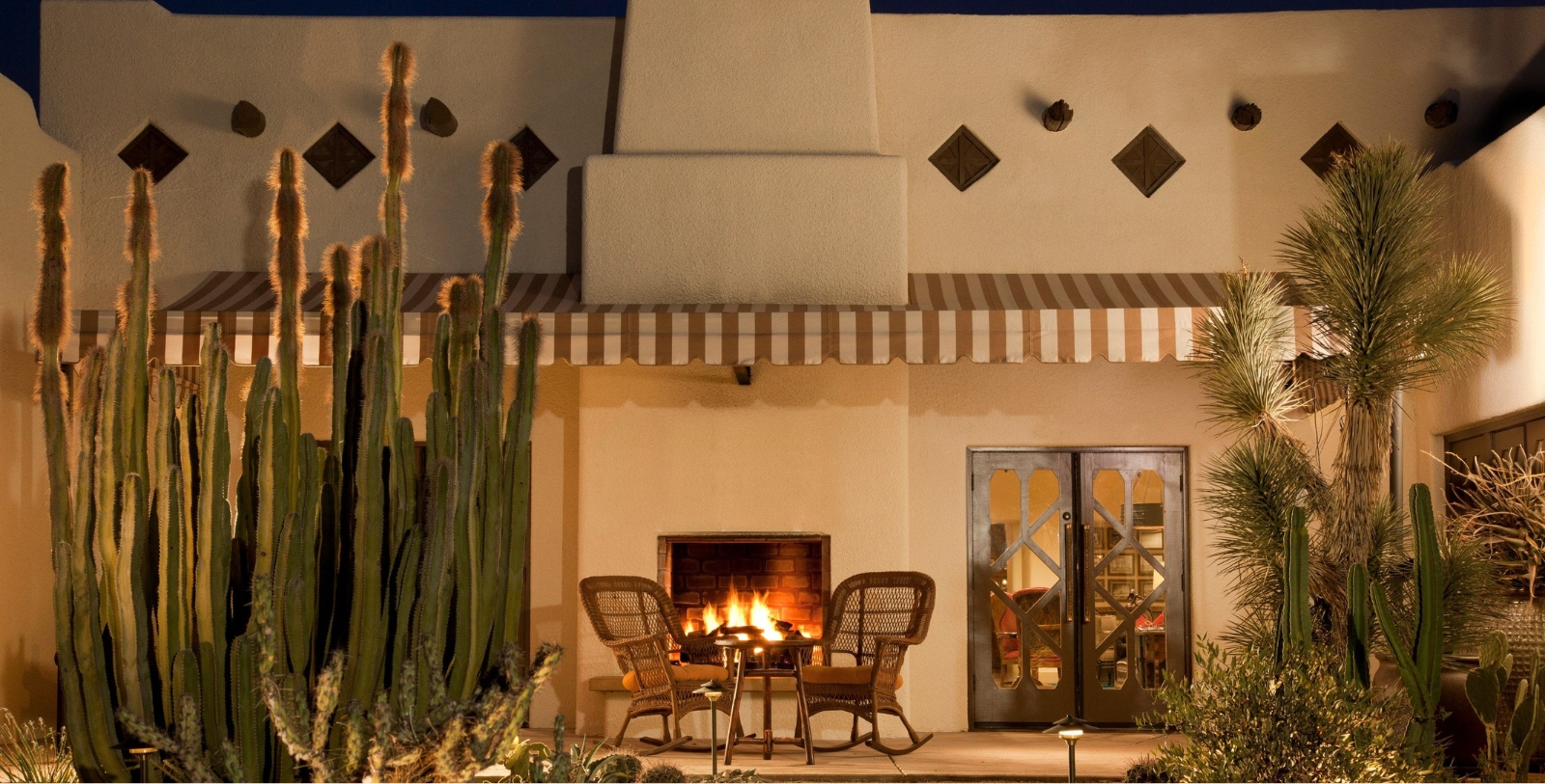 a patio with chairs and a fire pit