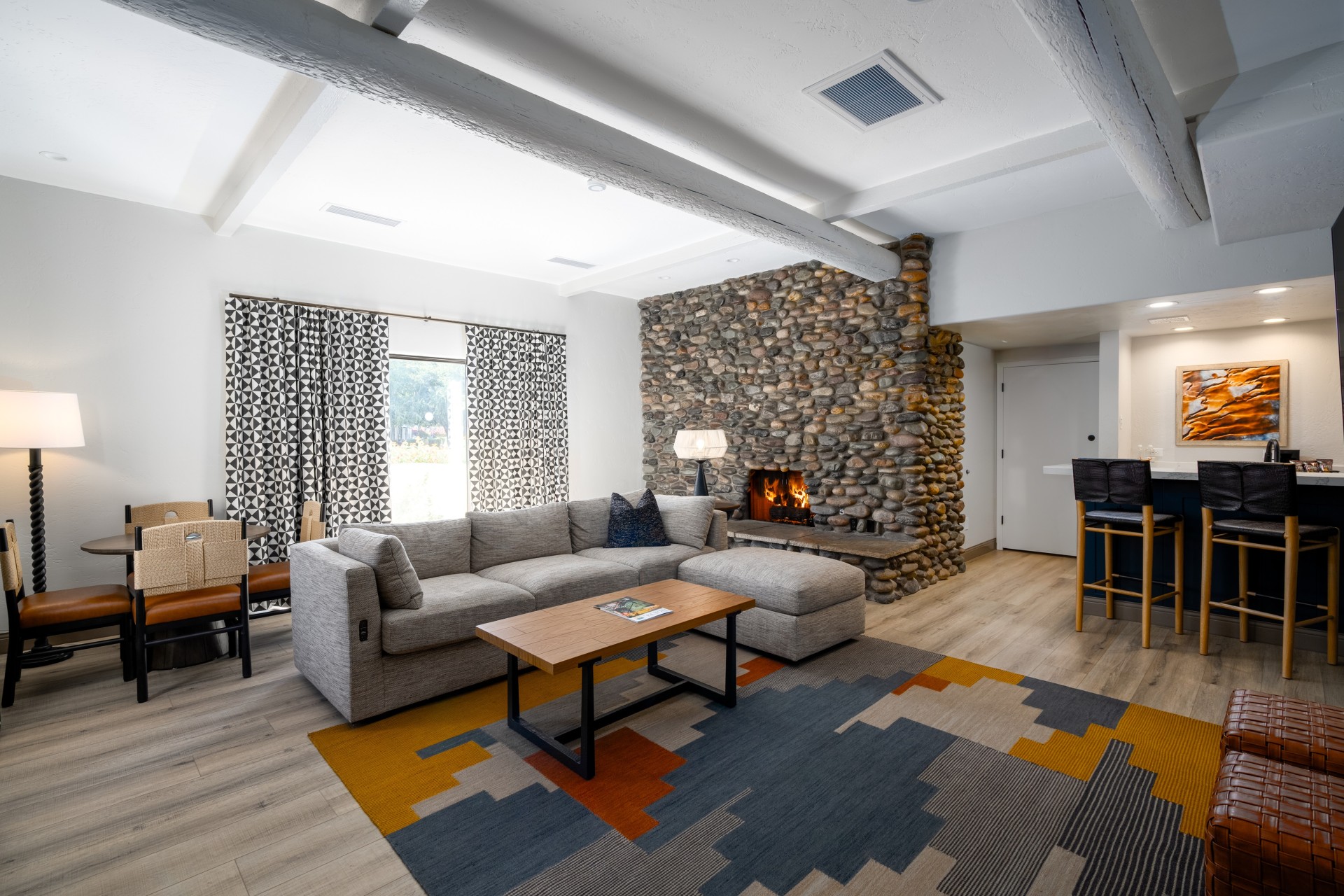 a living room with a stone fireplace and couch