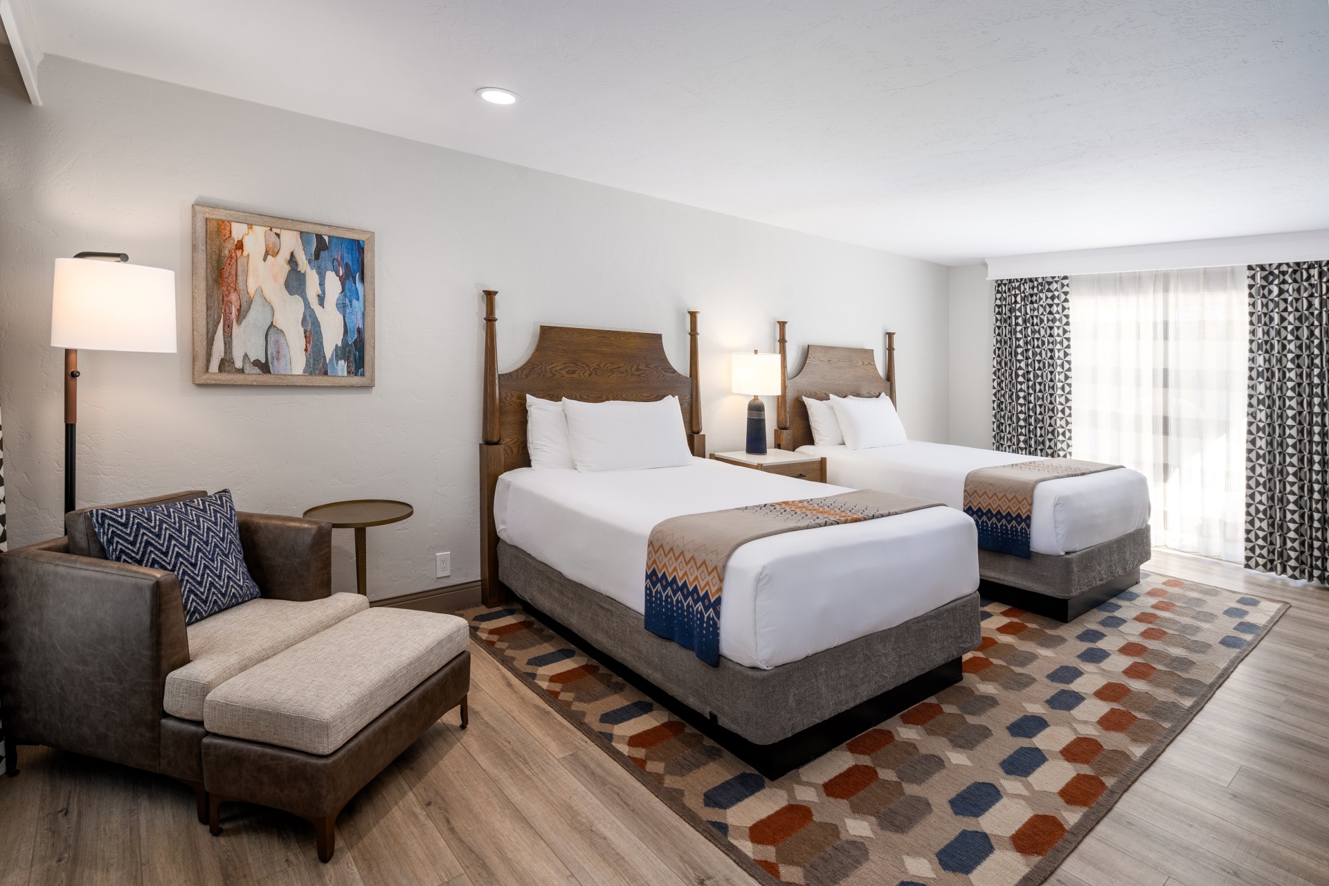 a room with two beds and a chair