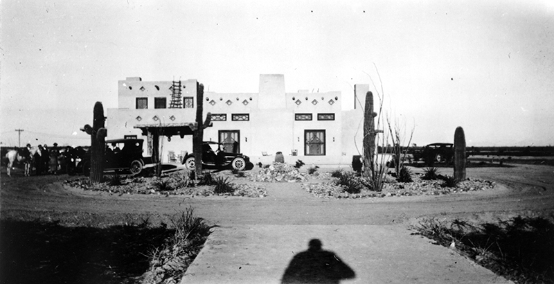 a shadow of a person in front of a house
