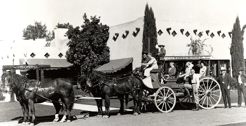 a horse drawn carriage with people on it