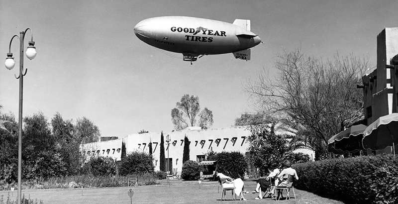 a blimp flying over a building