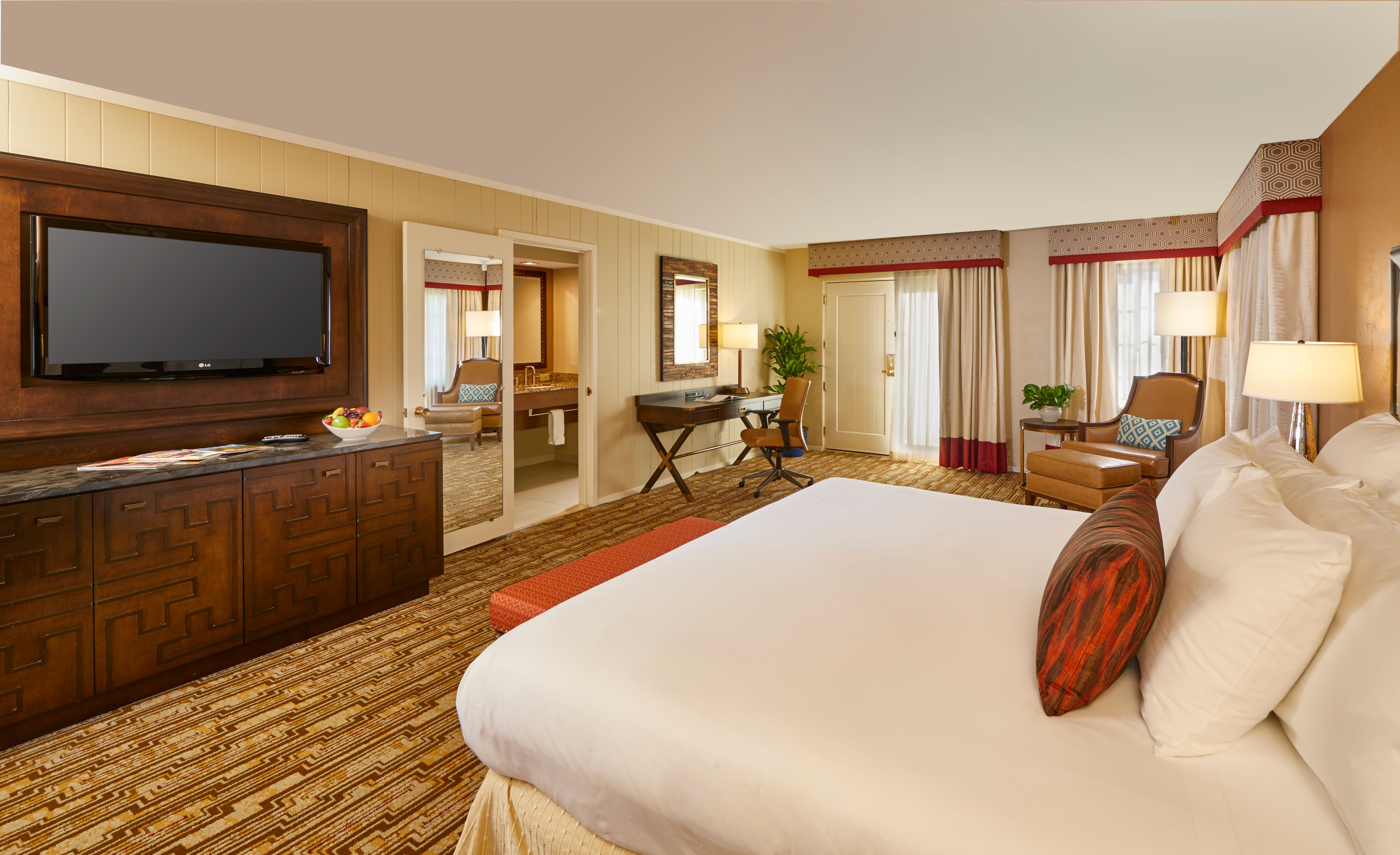 a room with a bed and a television