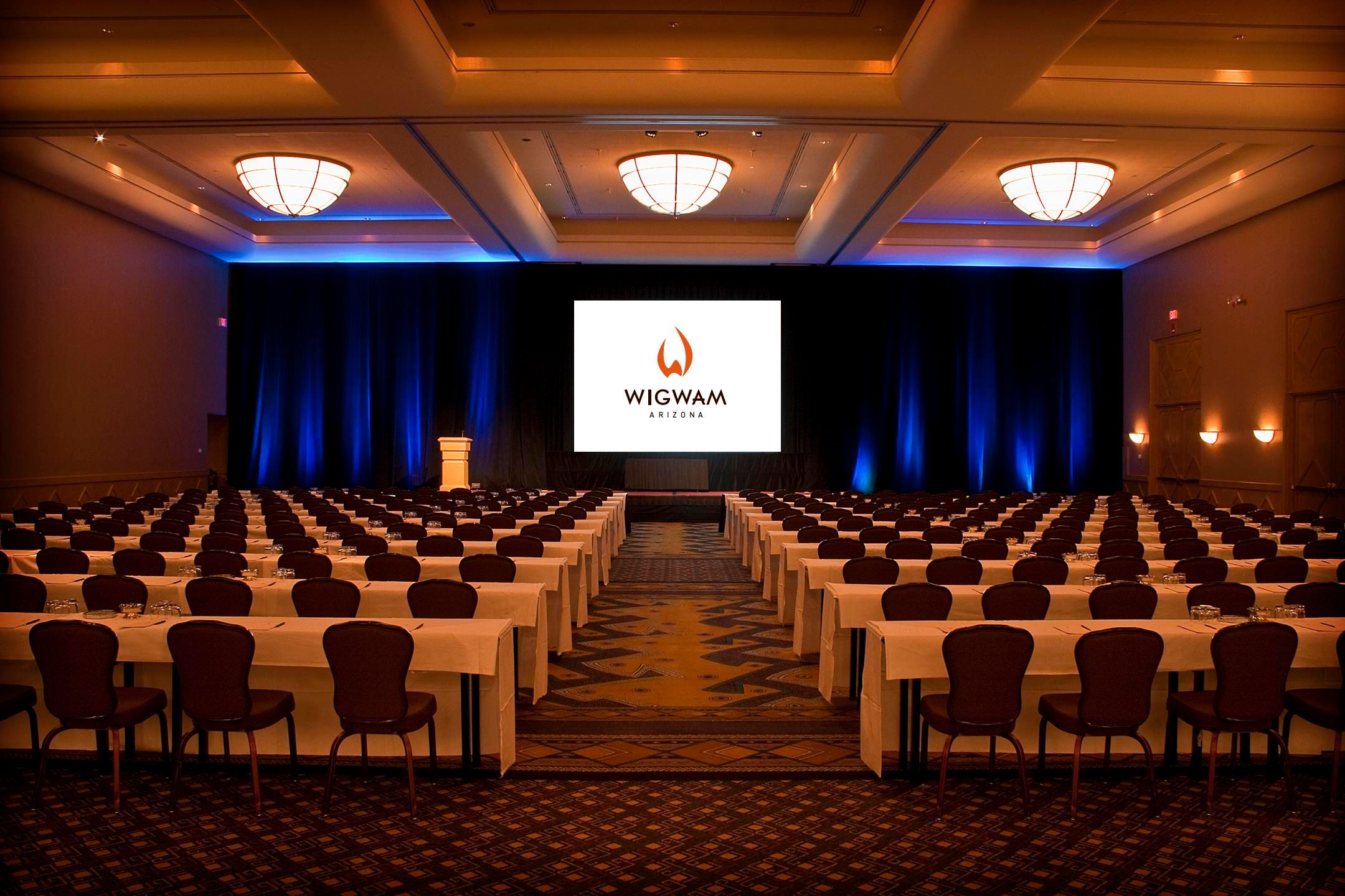 a room with a large screen and chairs