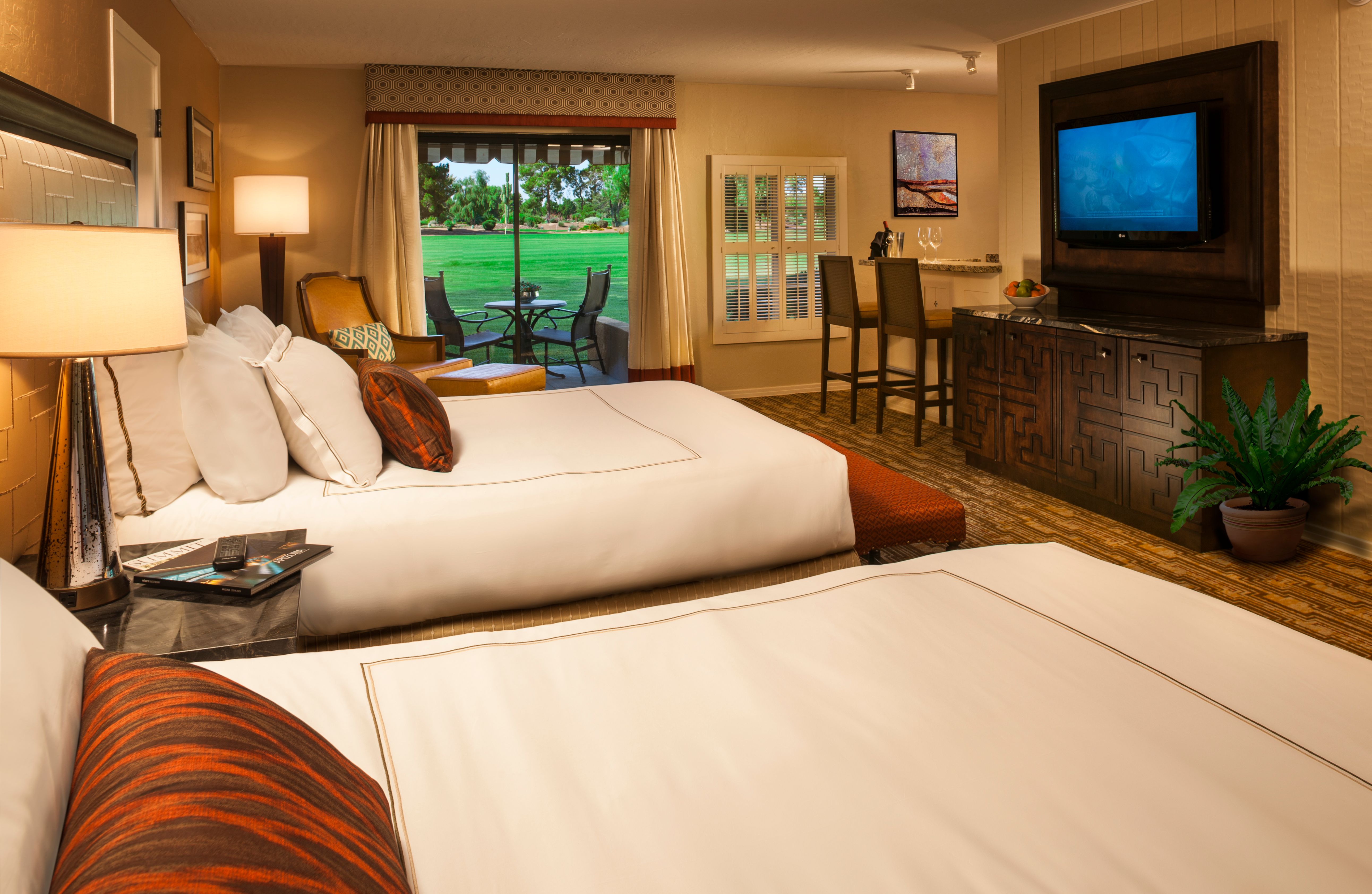 a room with two beds and a television