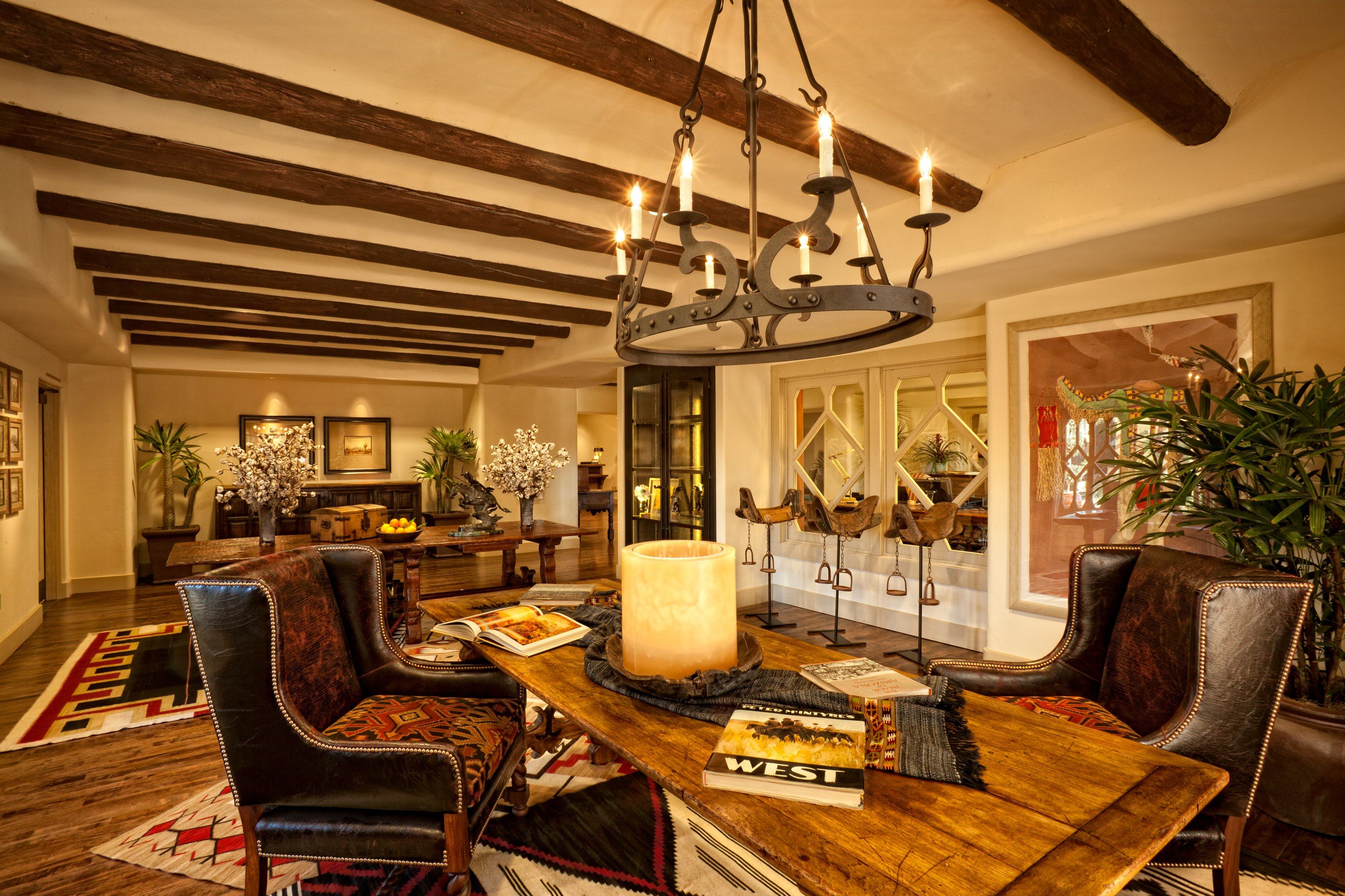 a room with a chandelier and a table with a candle