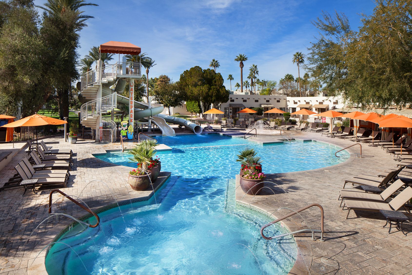 a pool with a slide and a slide