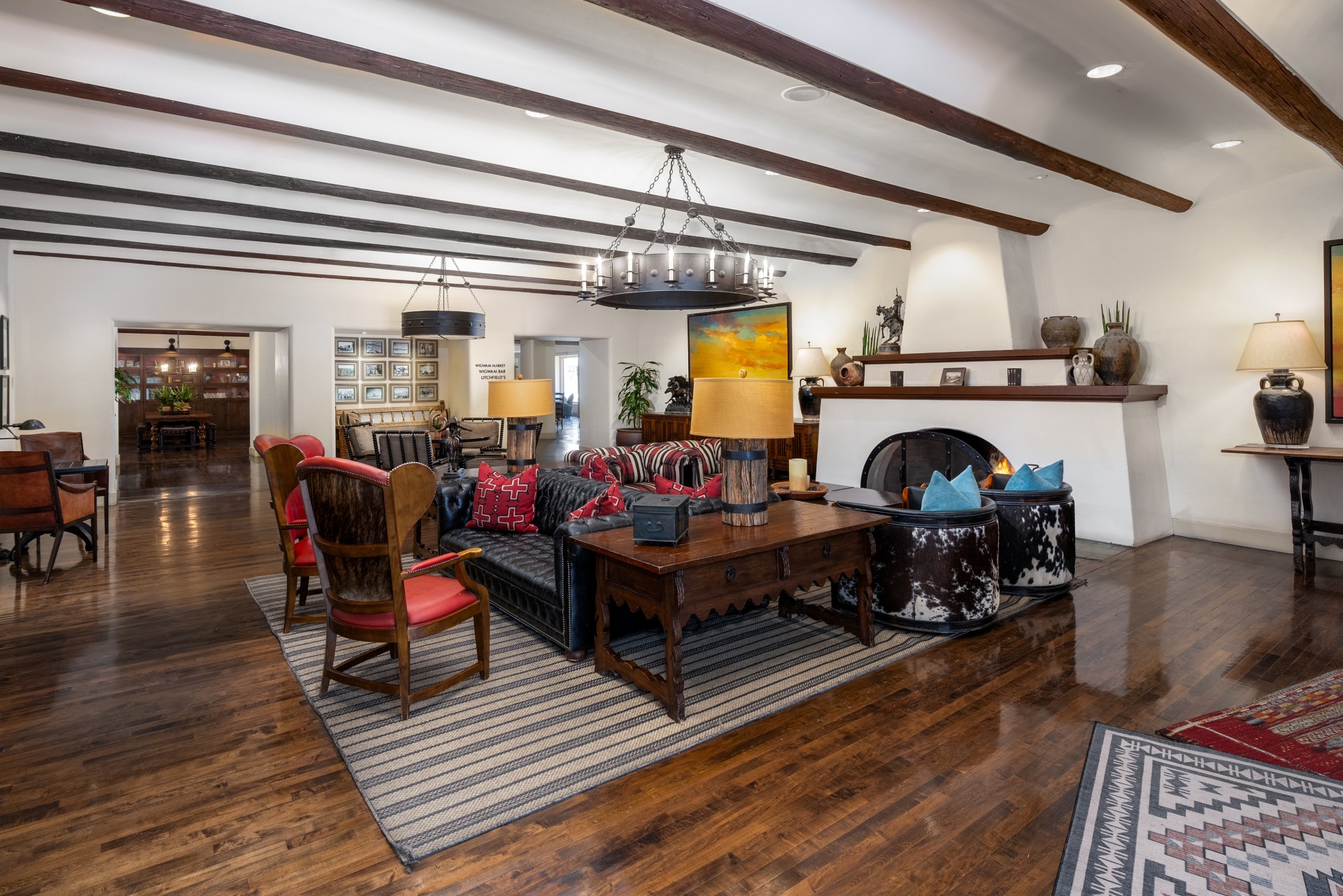 a room with a couch and chairs