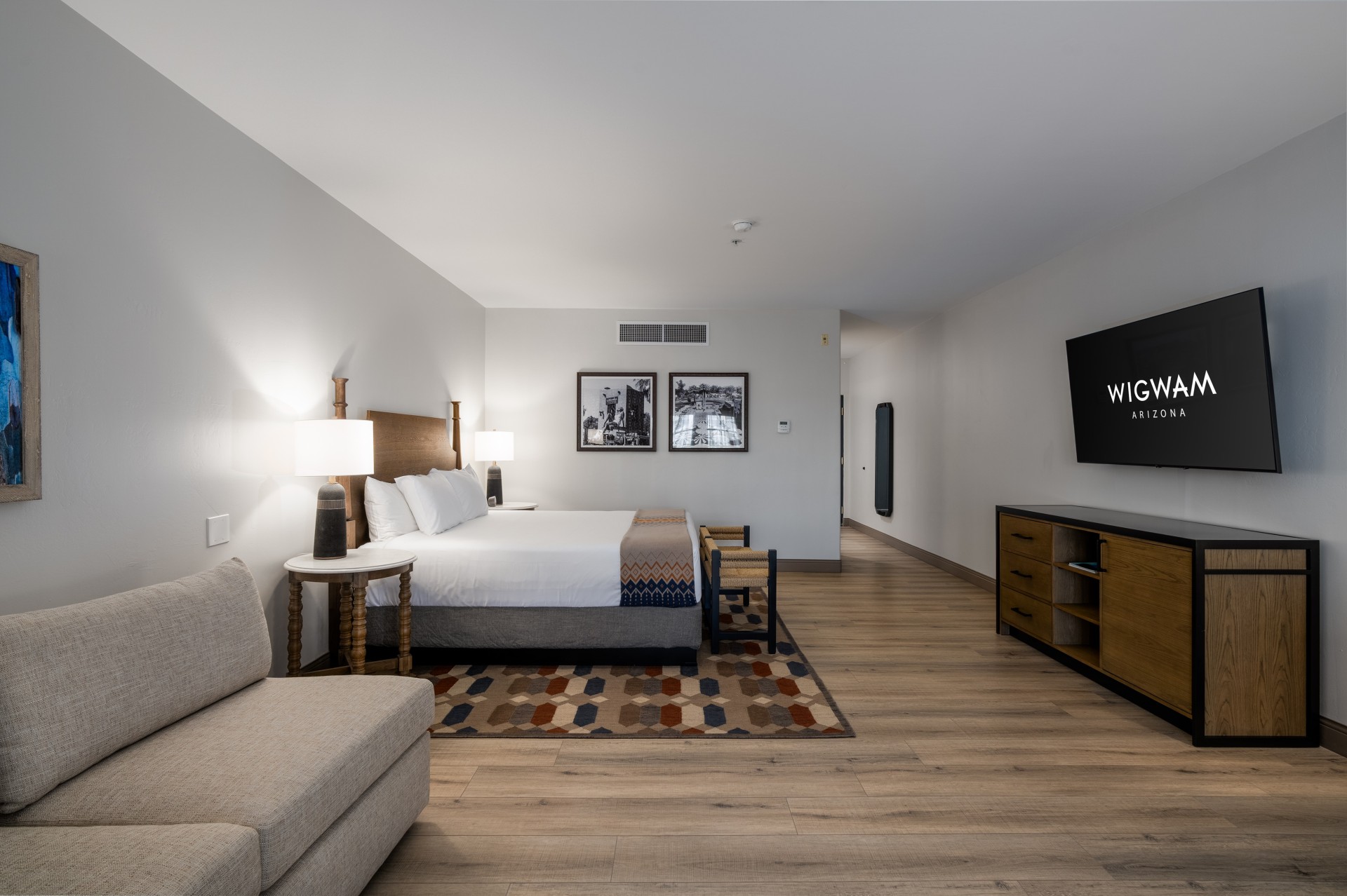 a room with a bed and a television
