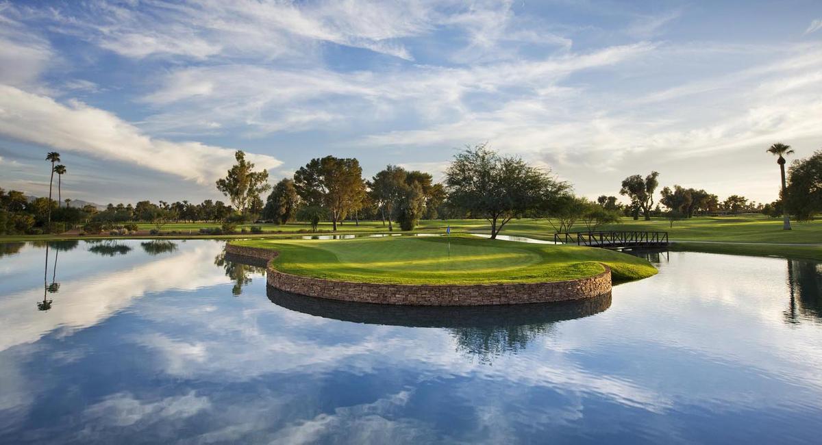 a golf course with a pond and a golf course
