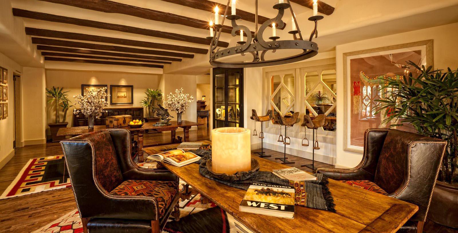 a living room with a chandelier and a candle on a table