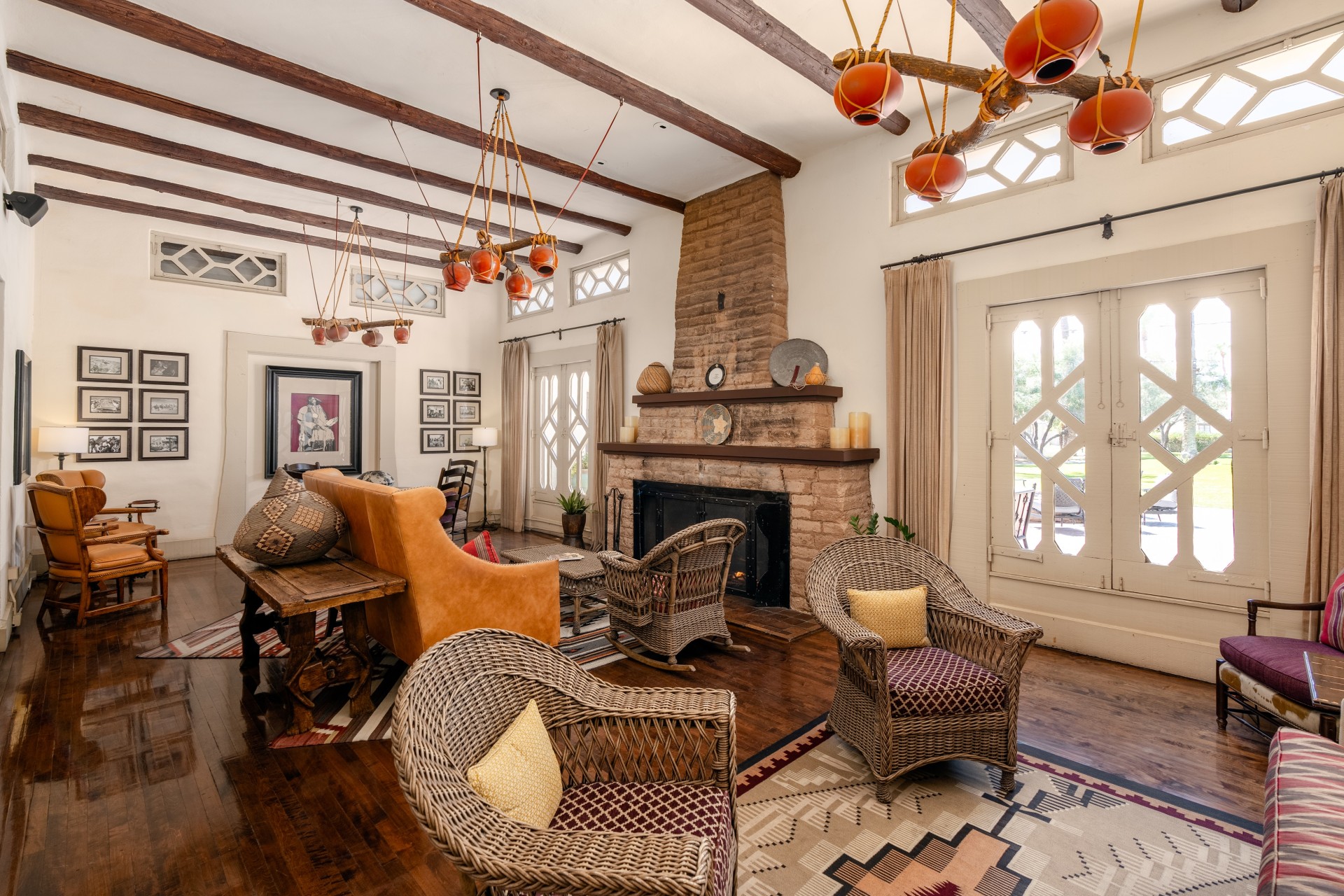 a living room with wicker chairs and a fireplace