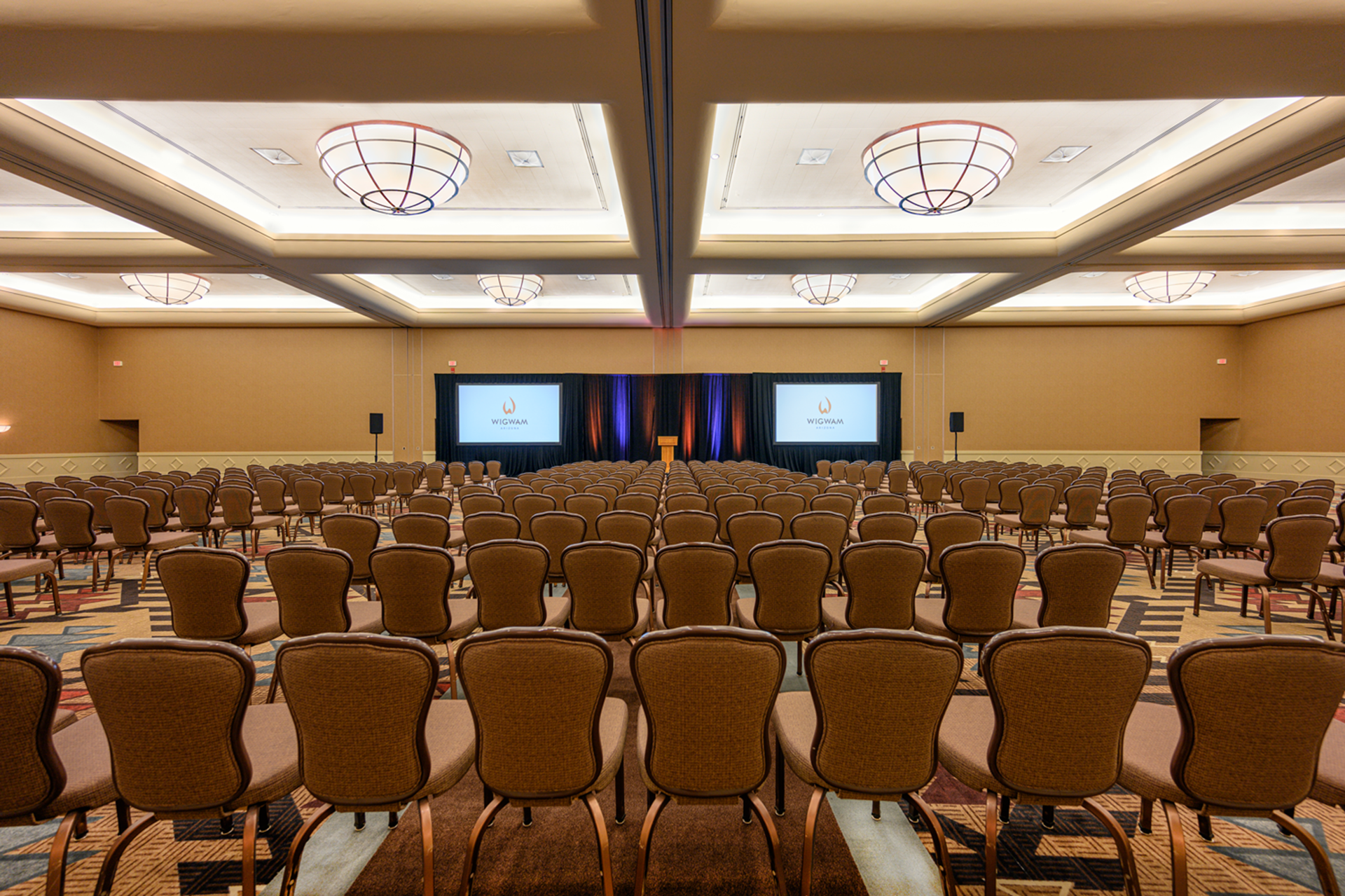a large room with chairs and a stage