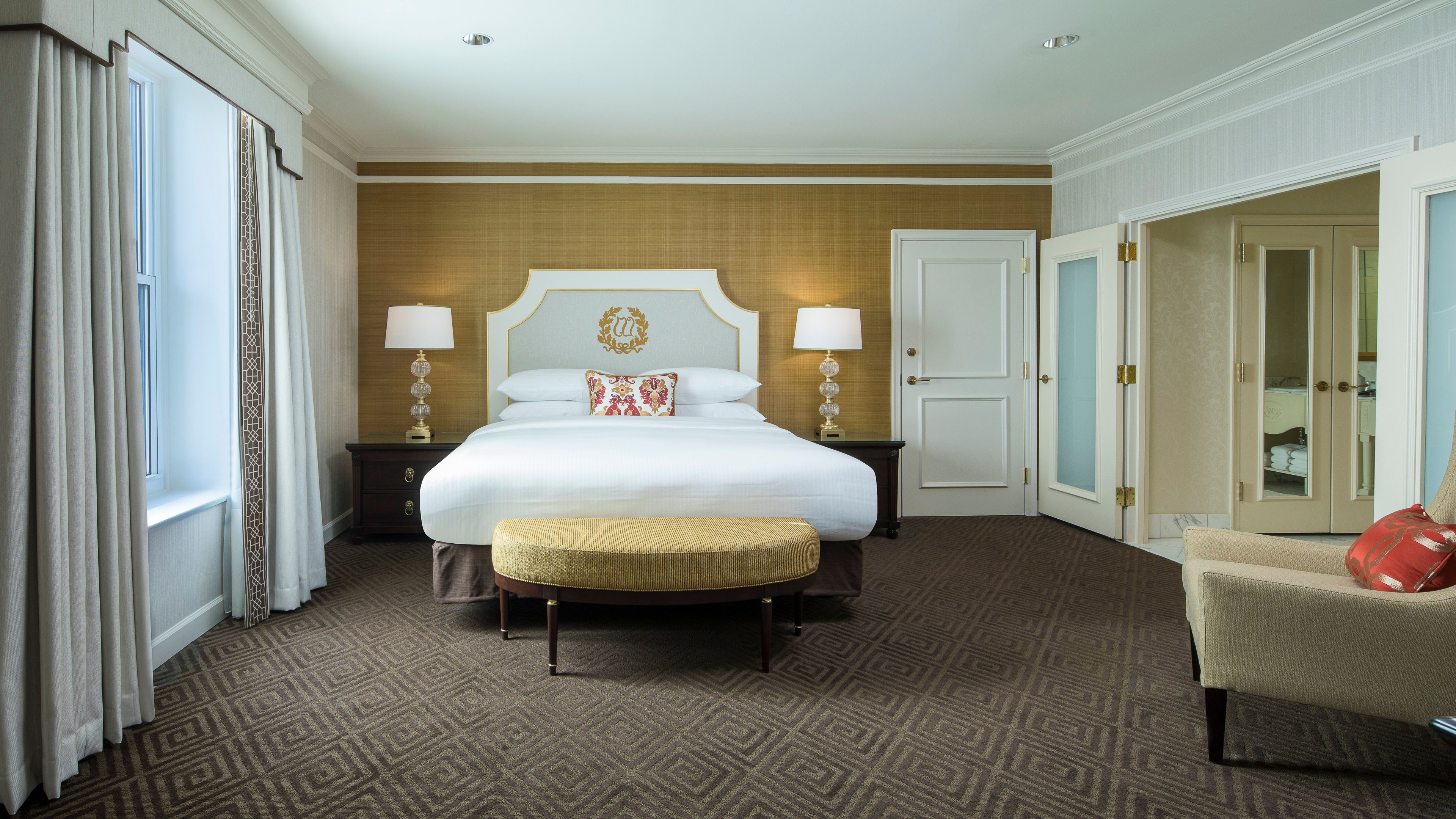 a bedroom with a bed and a bench
