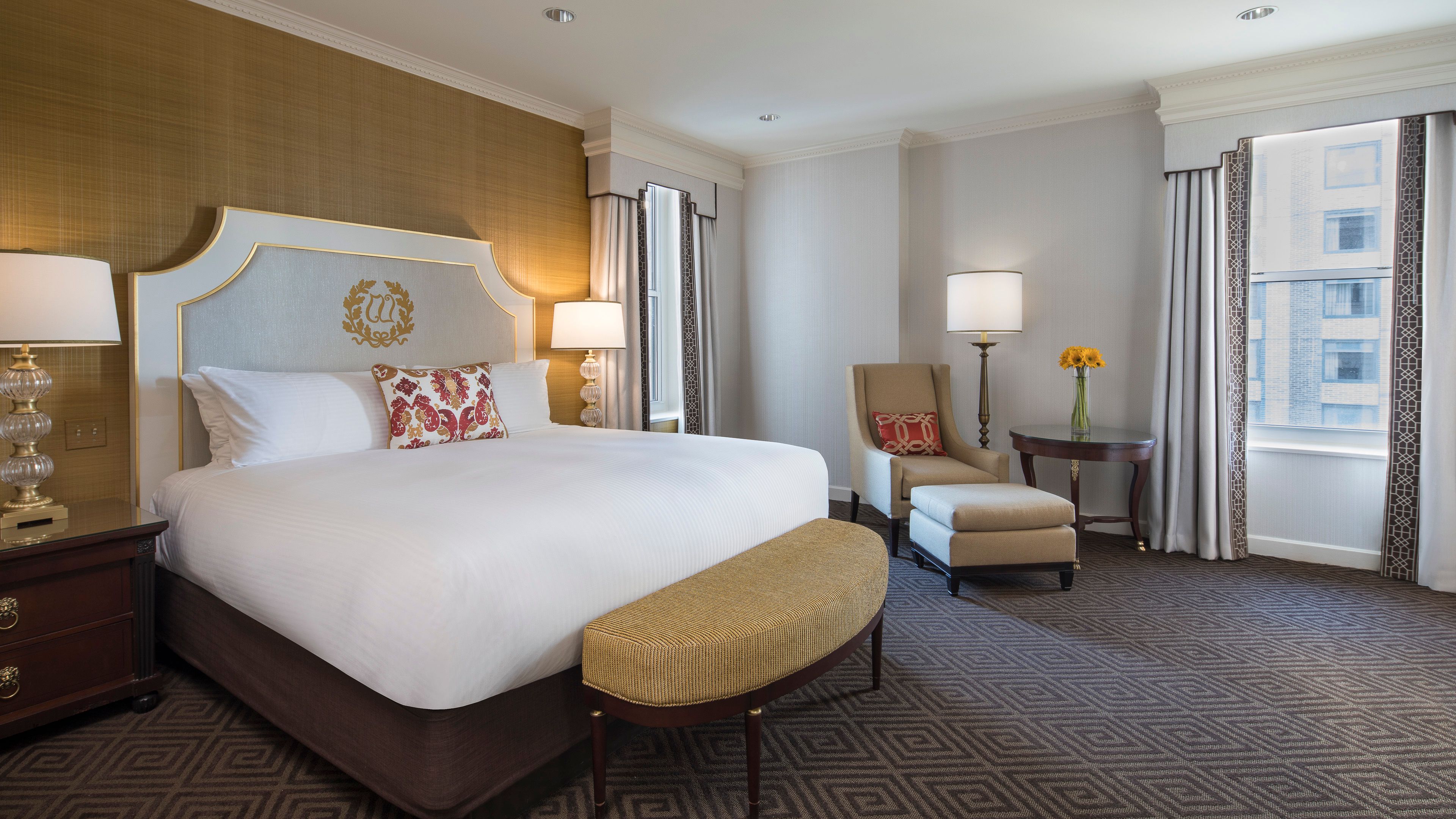 a hotel room with a bed and chairs