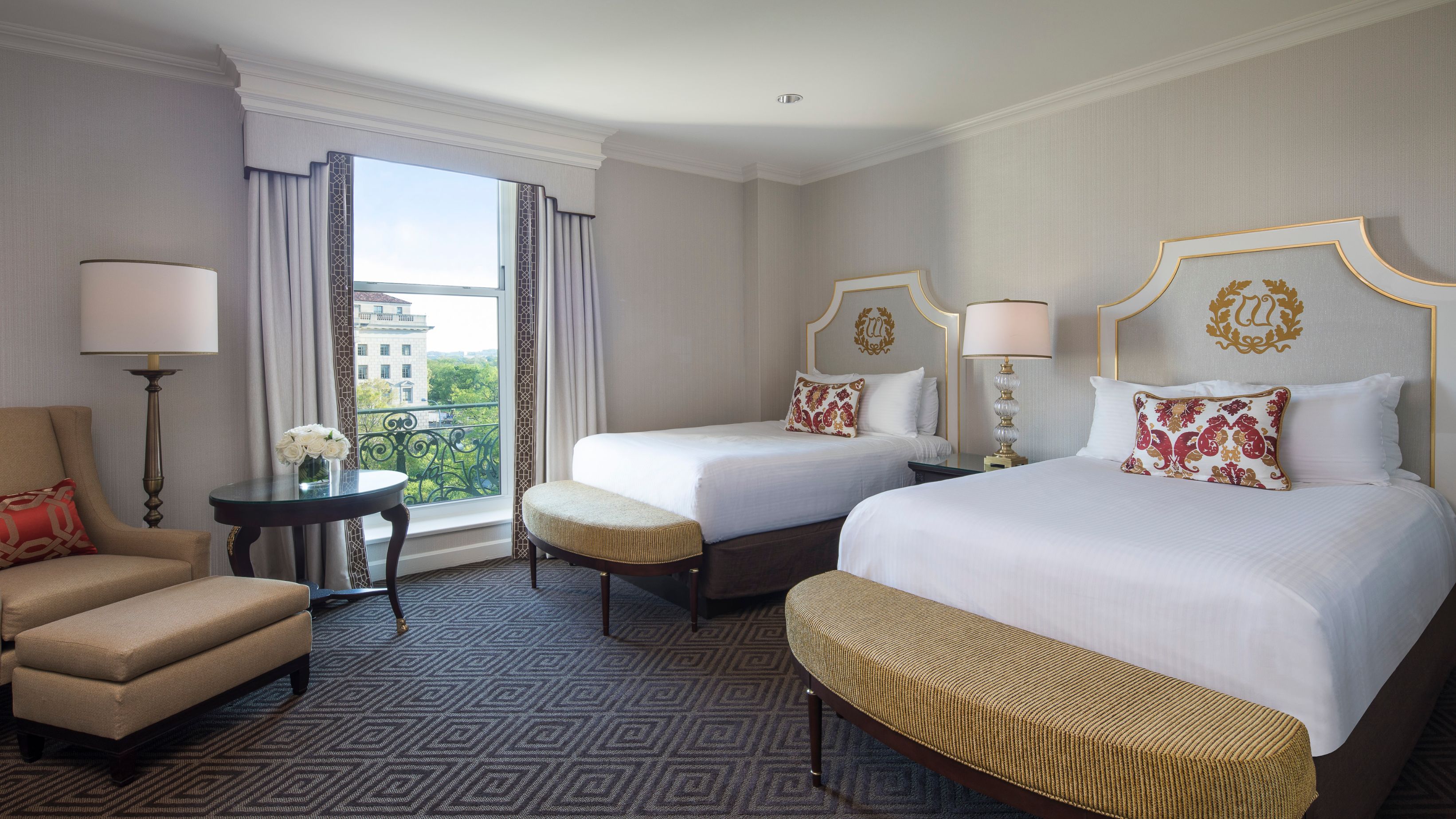 a room with two beds and a table