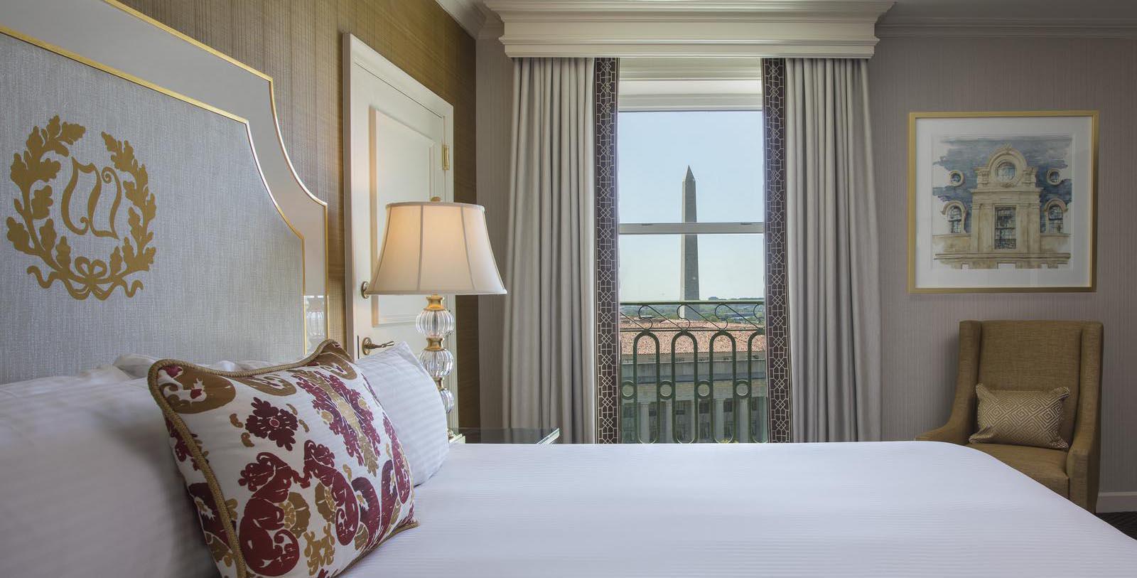 a bed with a lamp and a tower in the background