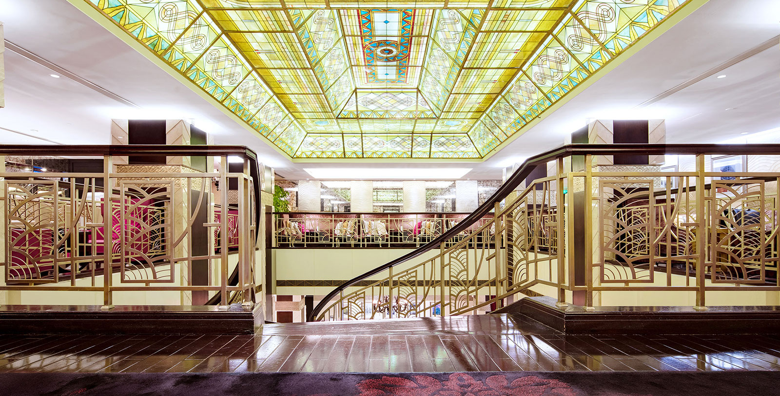 a staircase with stained glass ceiling