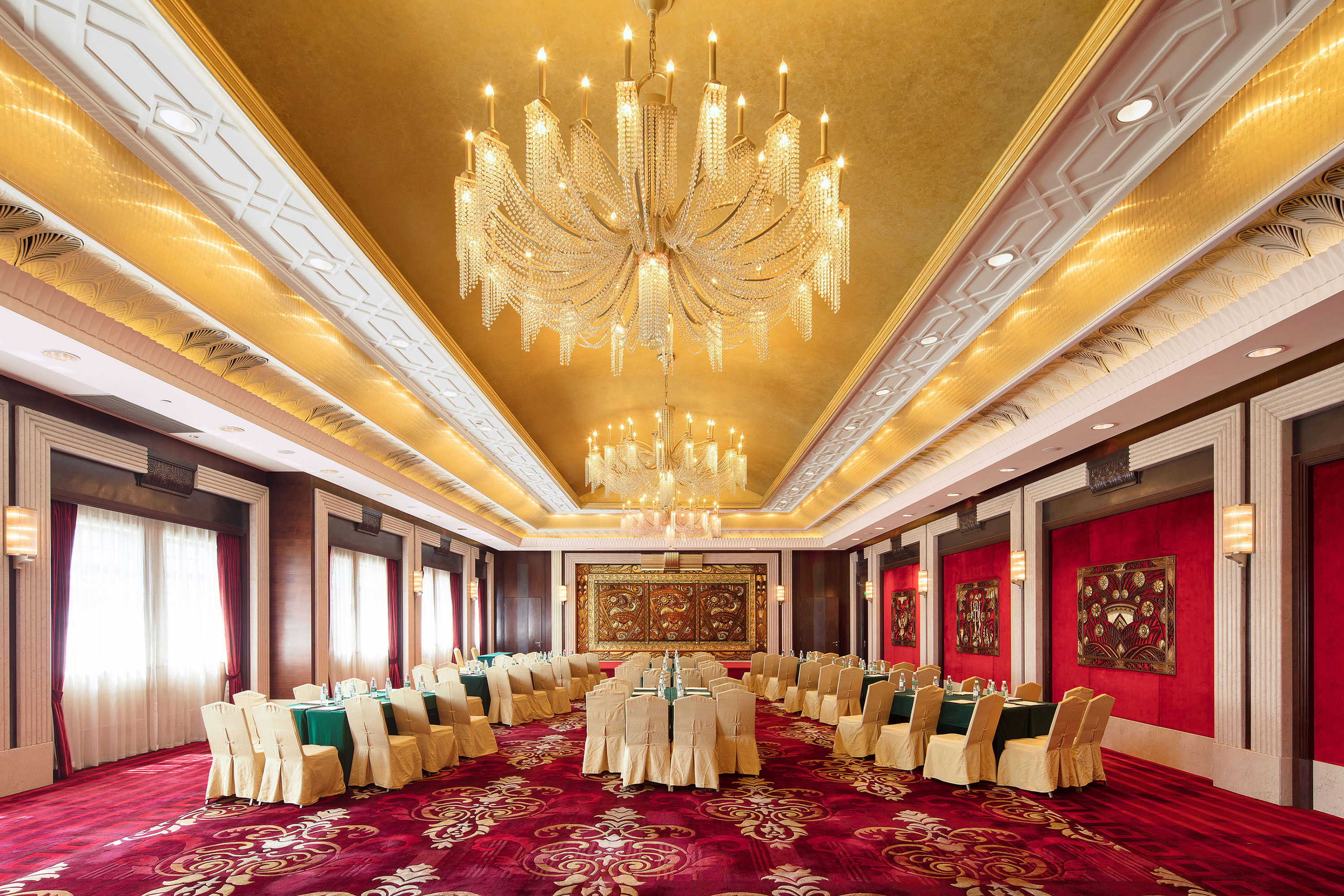 a room with a chandelier and tables
