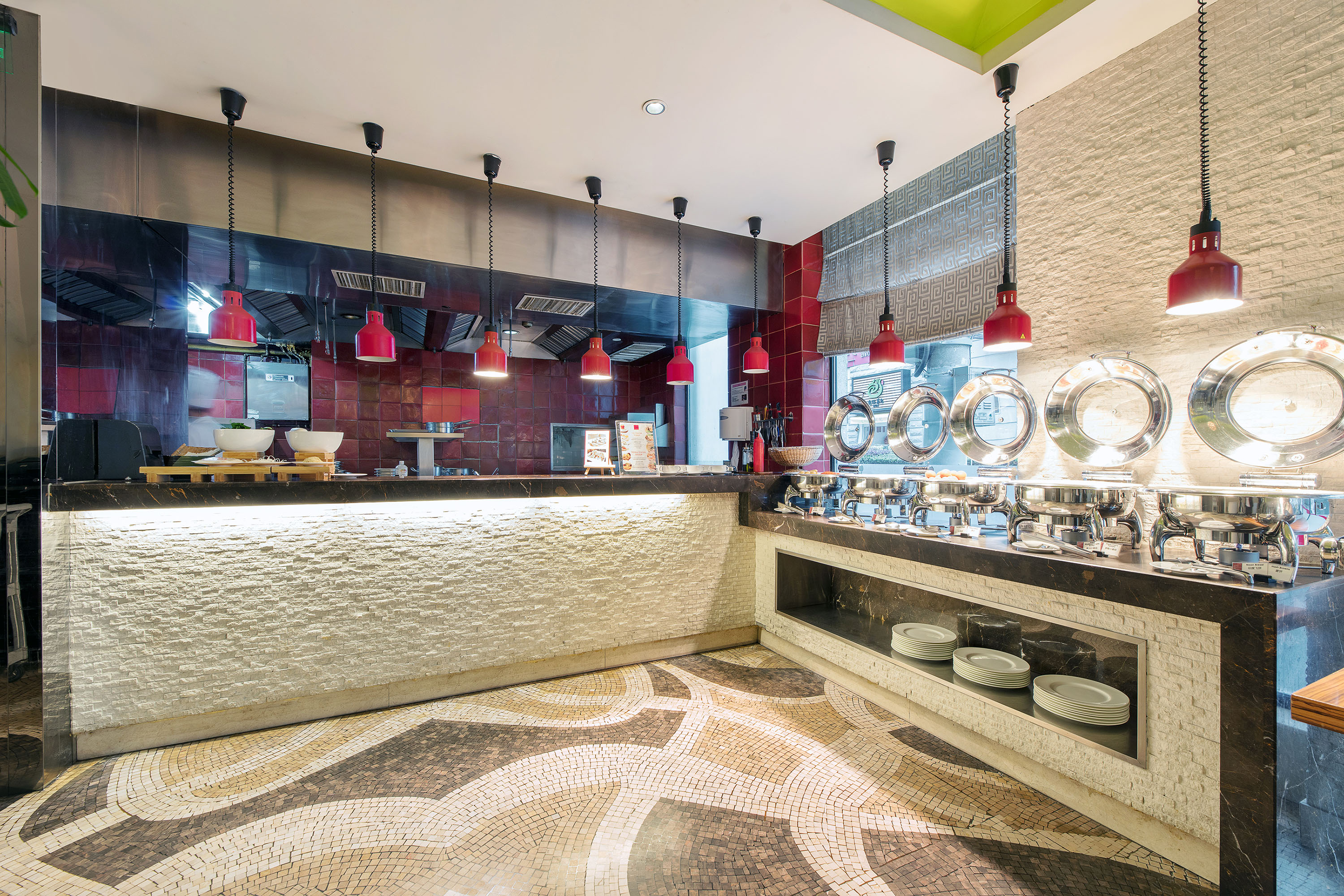 a restaurant with a counter and red lights