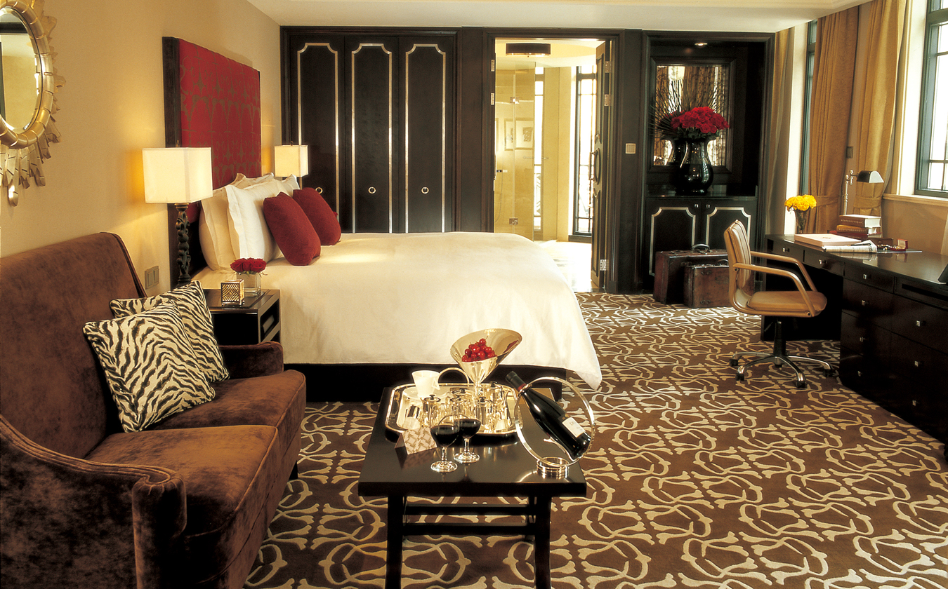 a hotel room with a bed and a coffee table