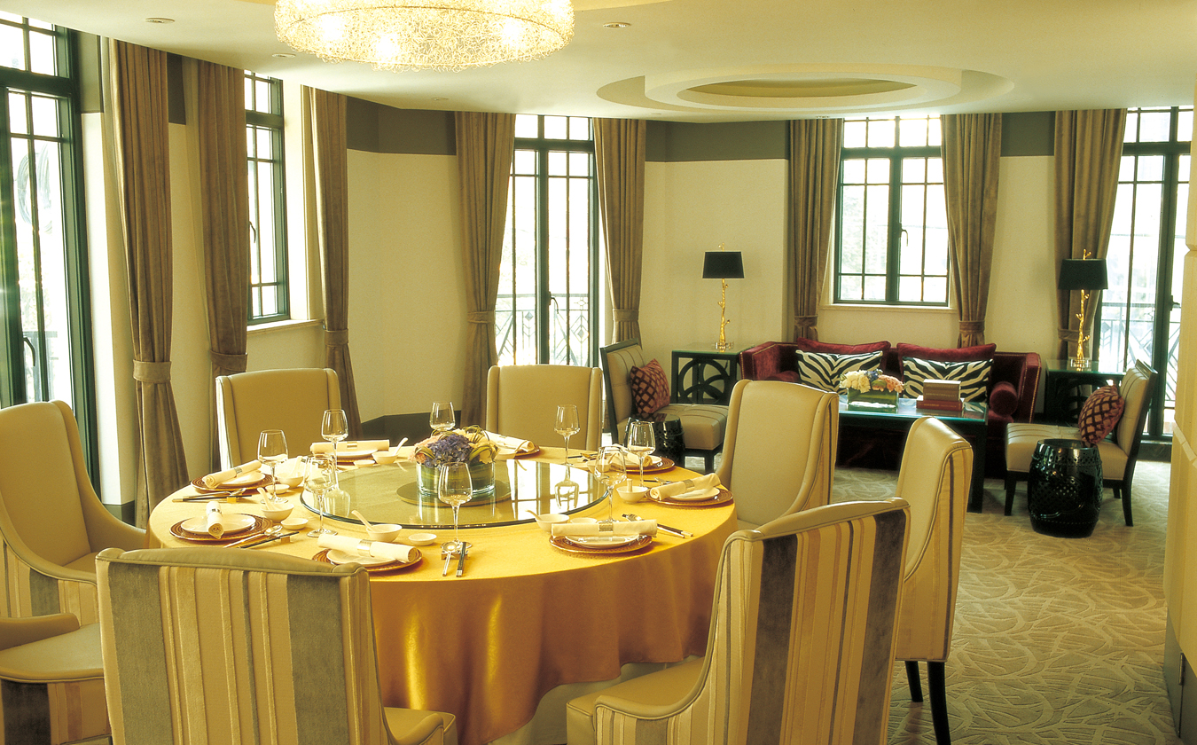 a dining room with a round table and chairs