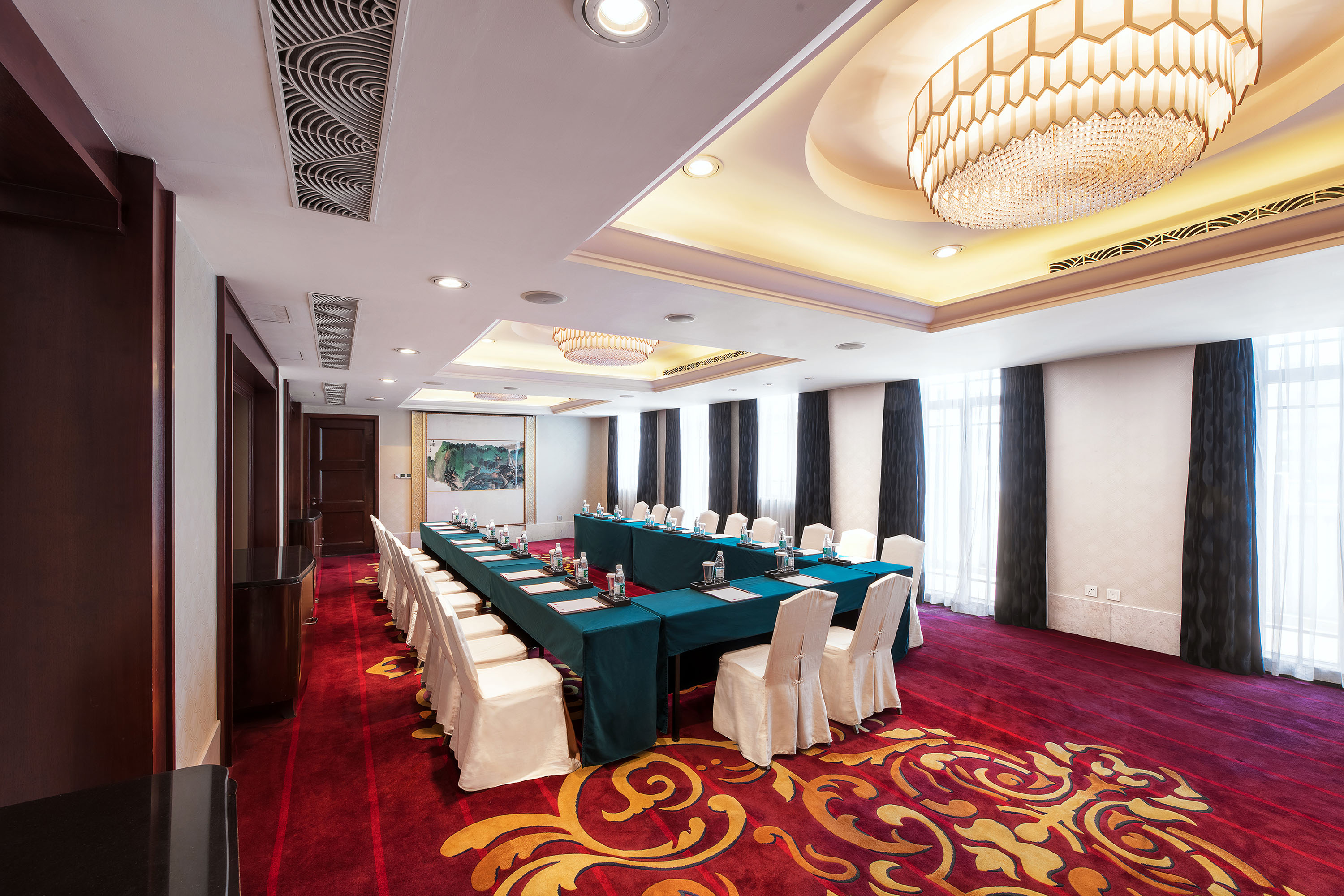 a room with a long table and chairs